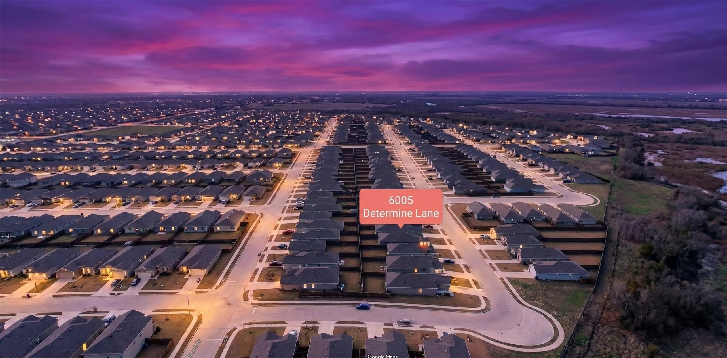 Planned residential community featuring uniformly styled homes with dark roofs and light exteriors