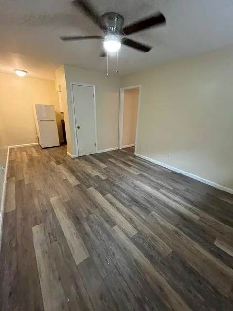 Wood-finish flooring throughout, complemented by light-toned wall paint