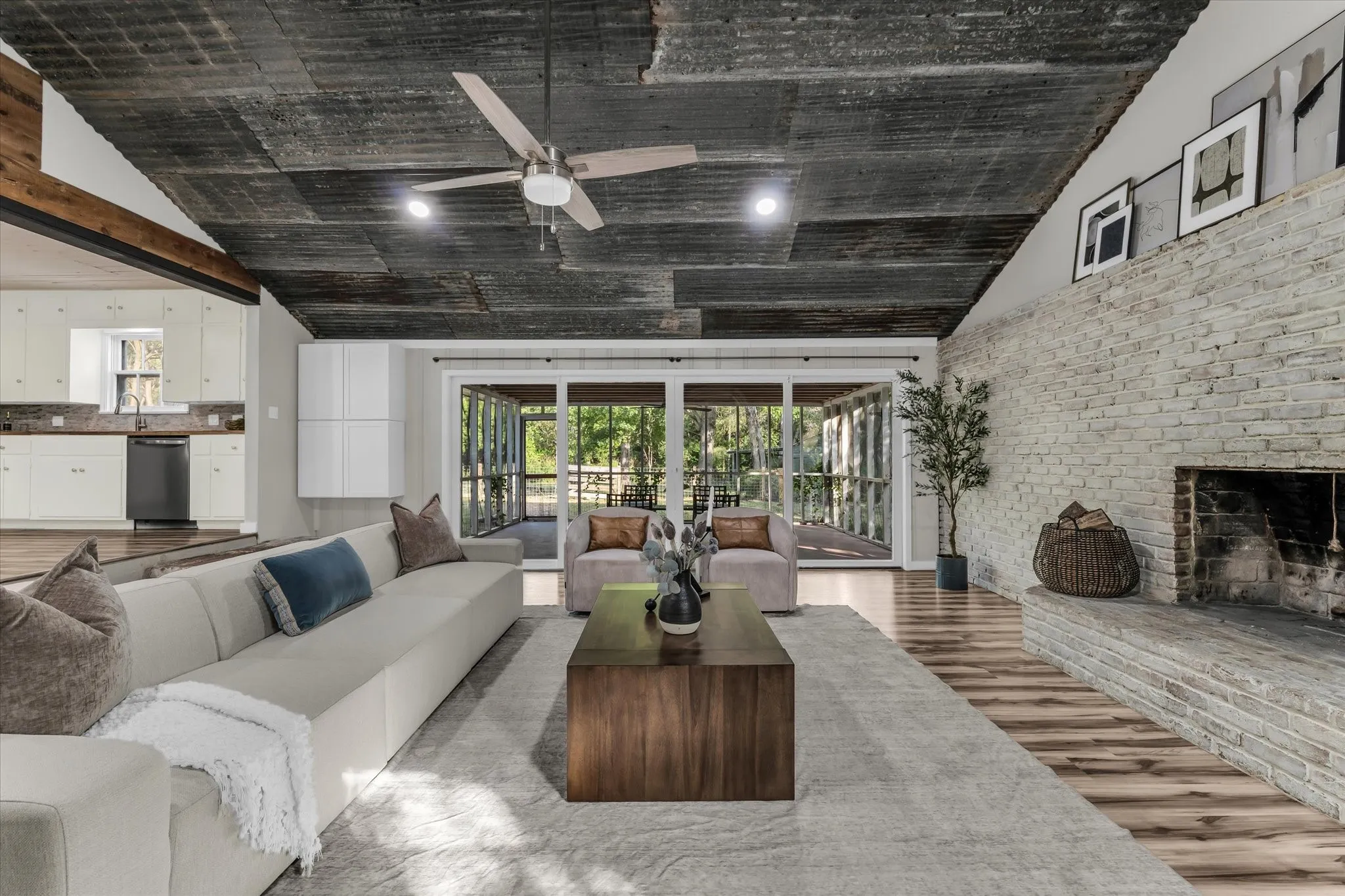 Living area featuring a natural wood-finish ceiling, a stone fireplace, and wood-finish flooring