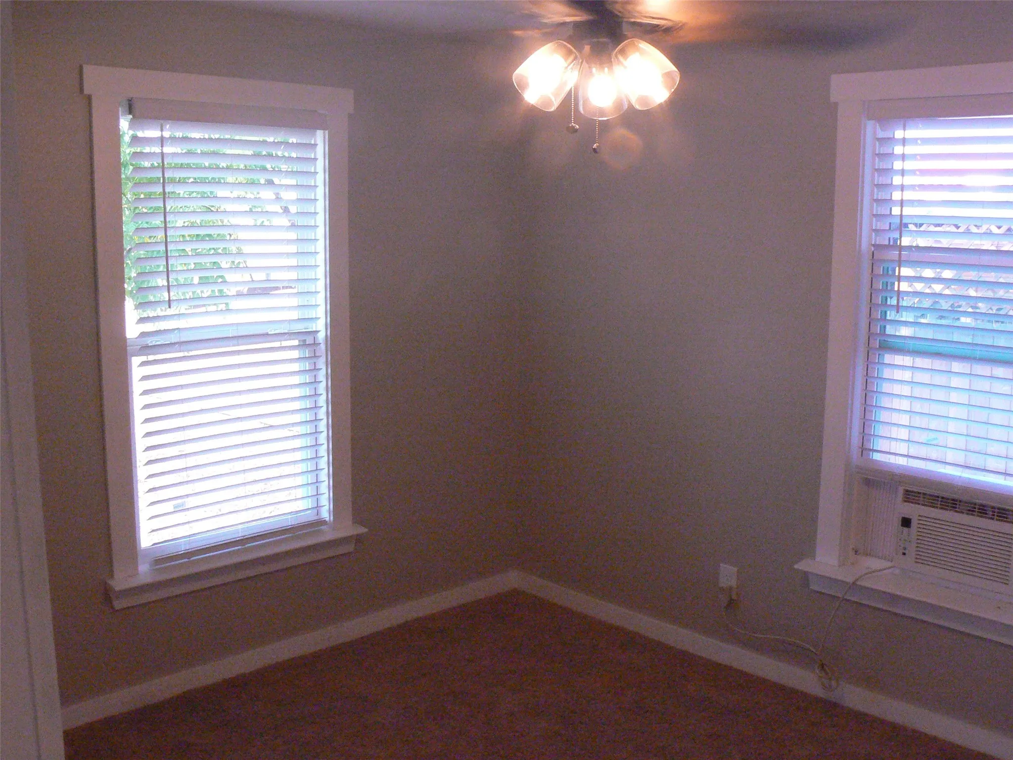 Bedroom is carpeted. Ceiling fan. Nice natural light. Mini-blinds.