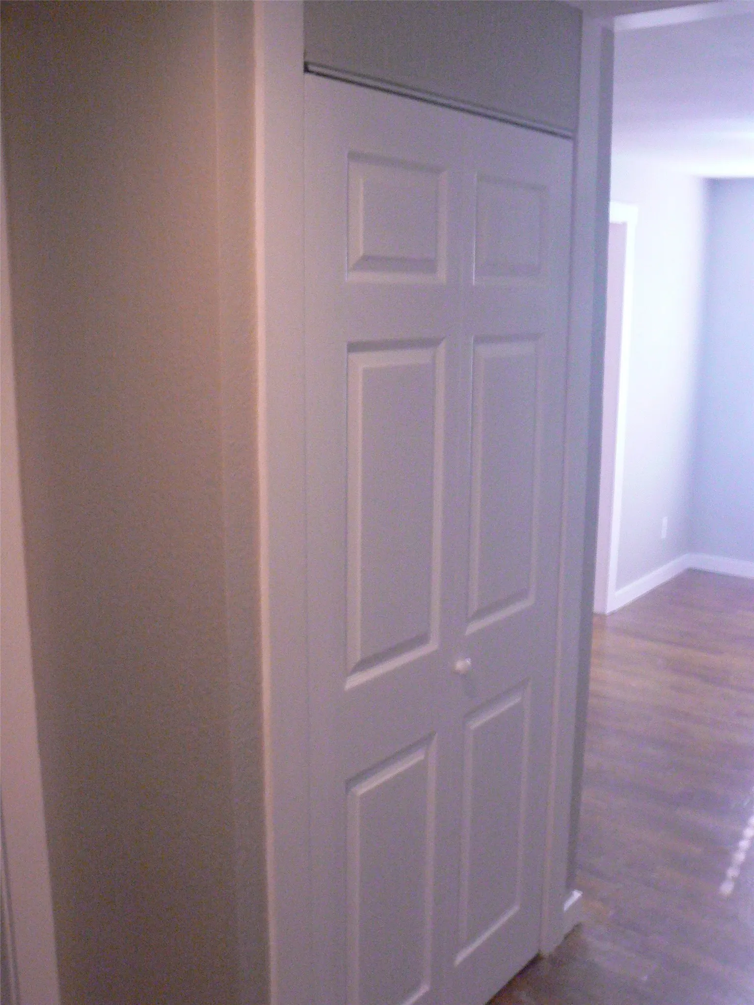 Utility closet with stack washer and dryer.