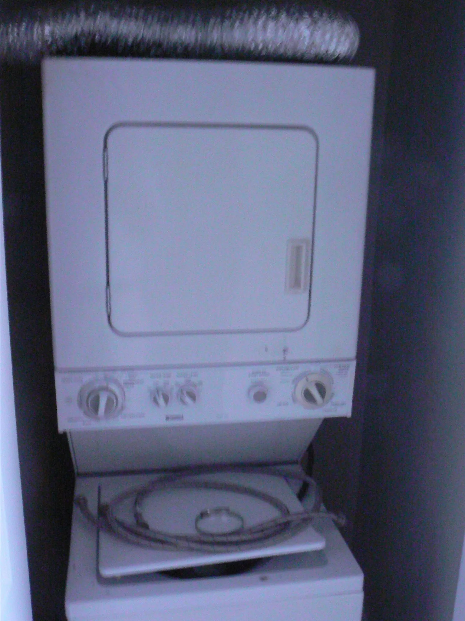 Stack washer and dryer in utility closet.