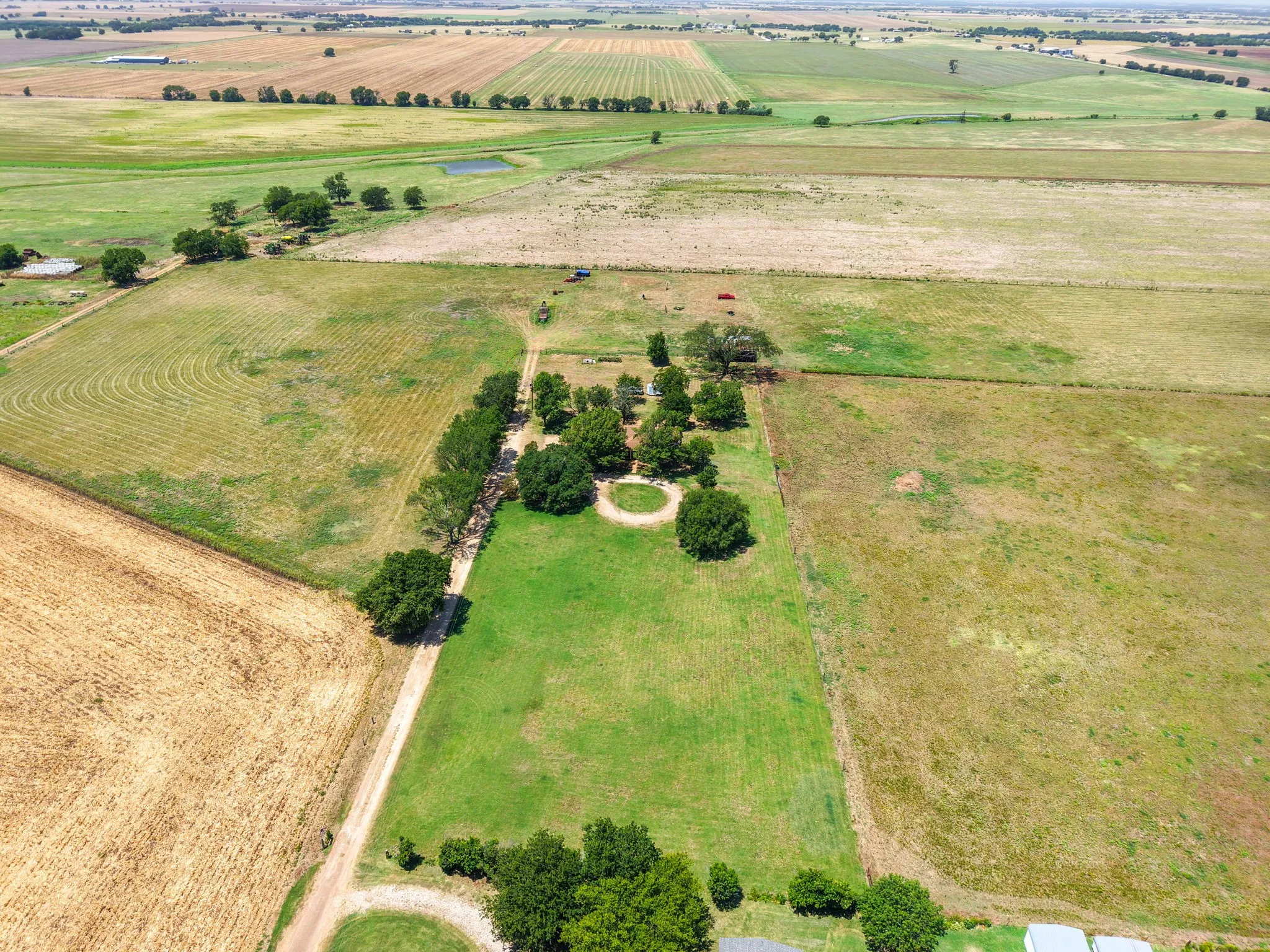 Expansive agricultural land featuring a mix of cultivated fields and pastures