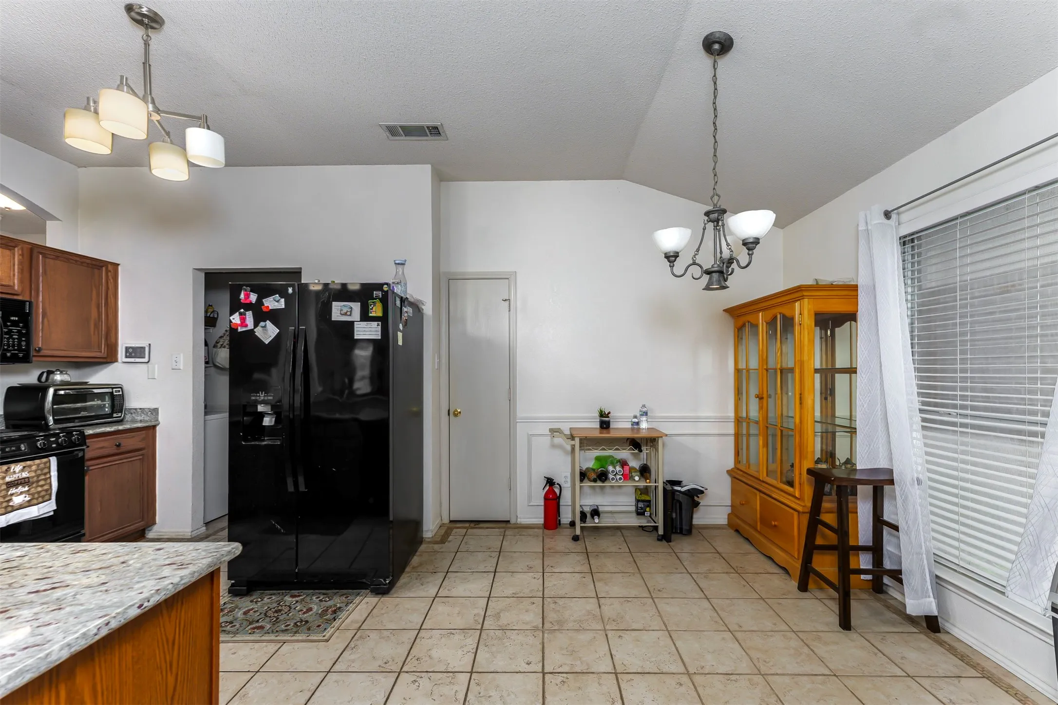 Kitchen area featuring tile flooring, granite-look countertops, and recessed lighting