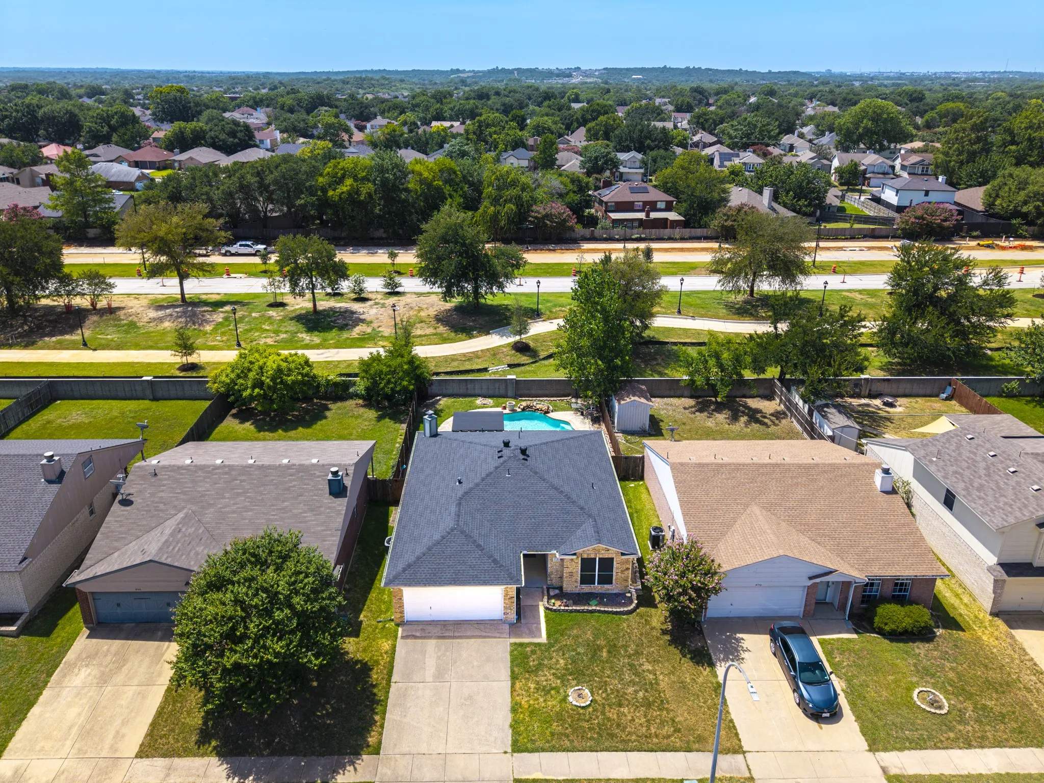 Single-story property featuring a dark shingle roof, attached garage, and a concrete driveway