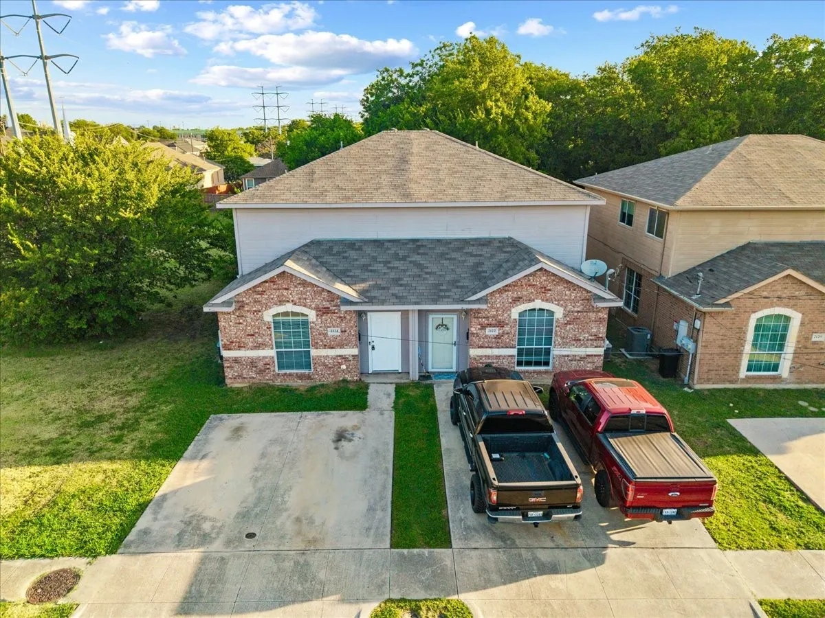 Duplex property featuring brick and siding exterior construction