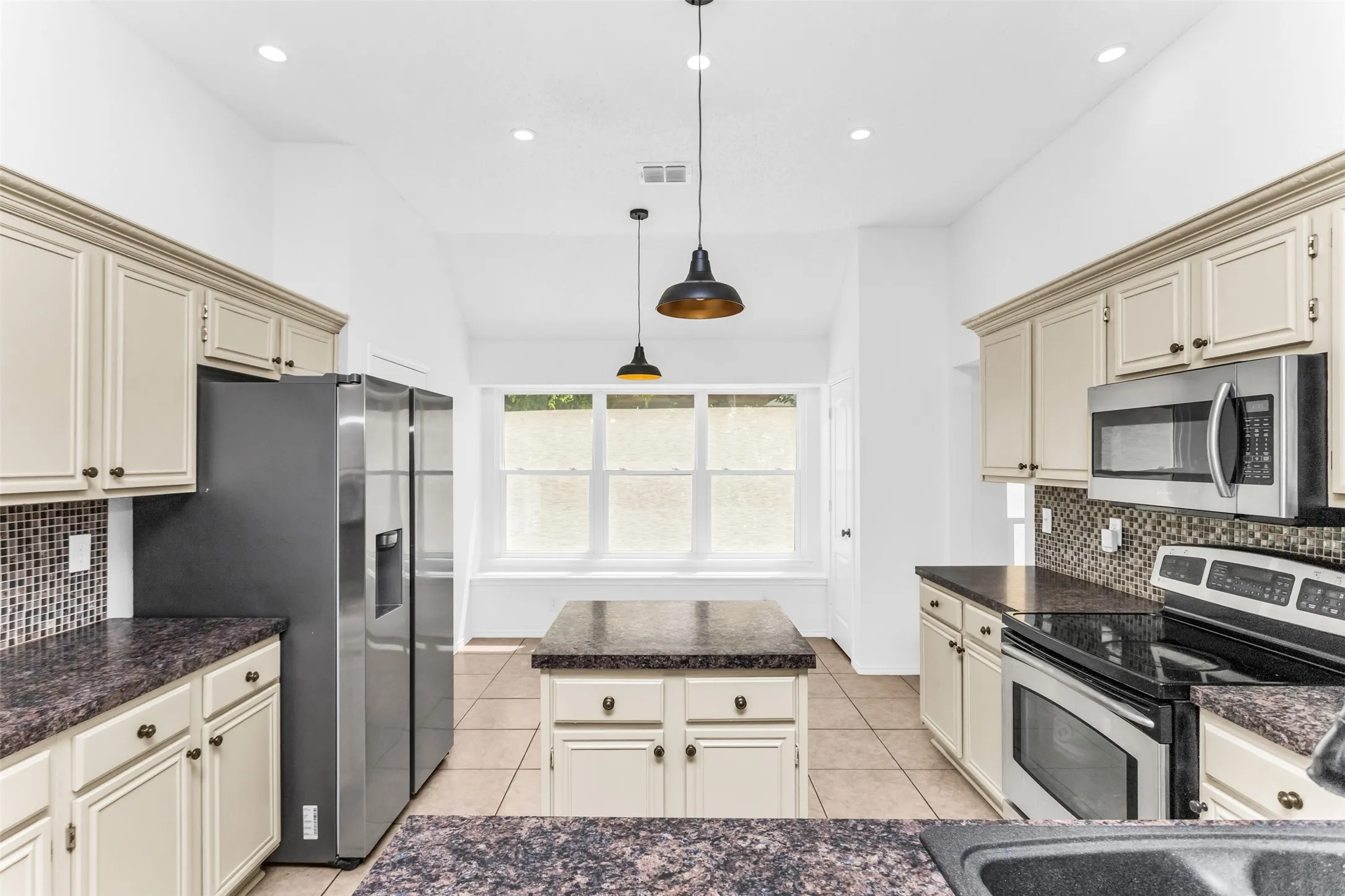 Kitchen featuring recessed lighting, a built-in oven, and a mosaic tile backsplash