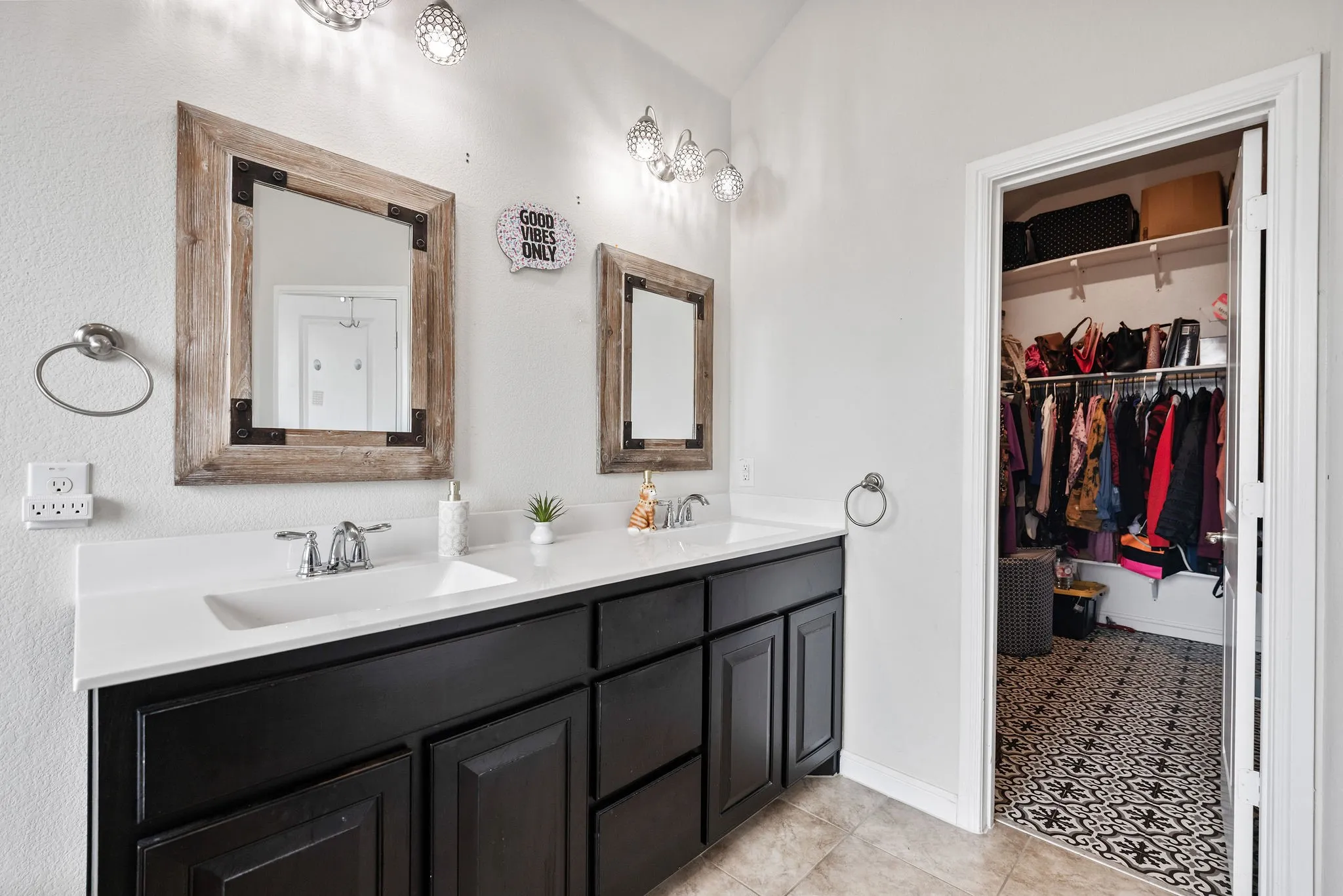 Double vanity featuring dark wood cabinetry, white countertops, and dual undermount sinks