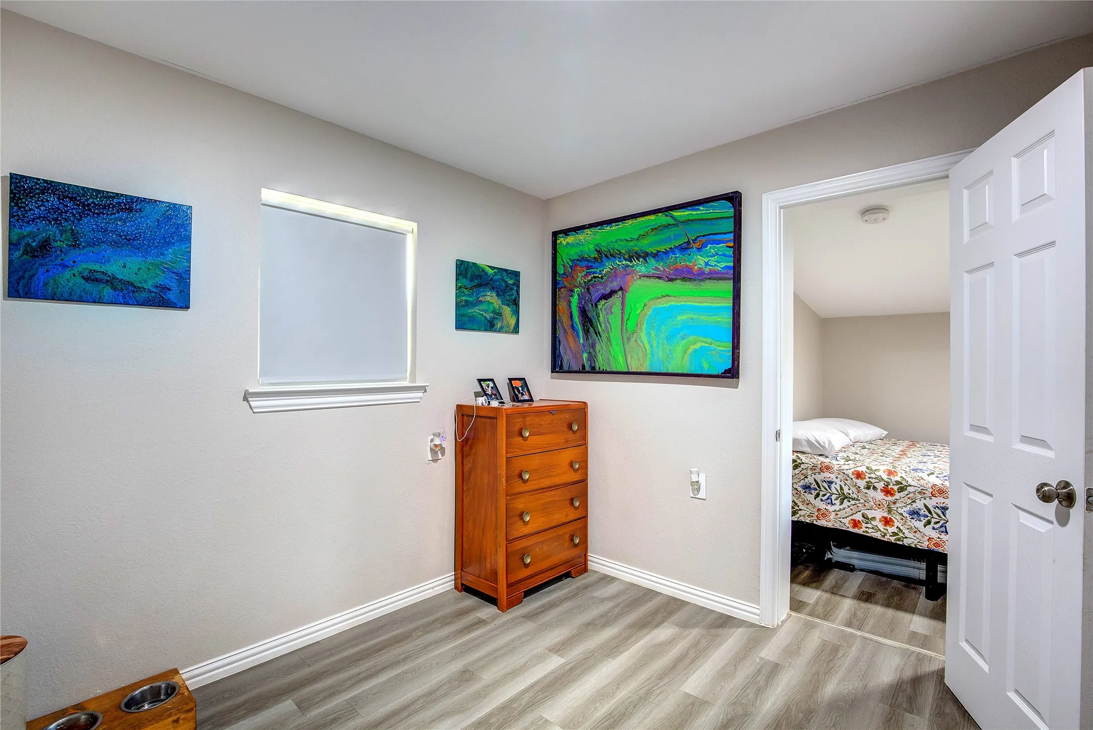 Bedroom with light wood-style floors and baseboards