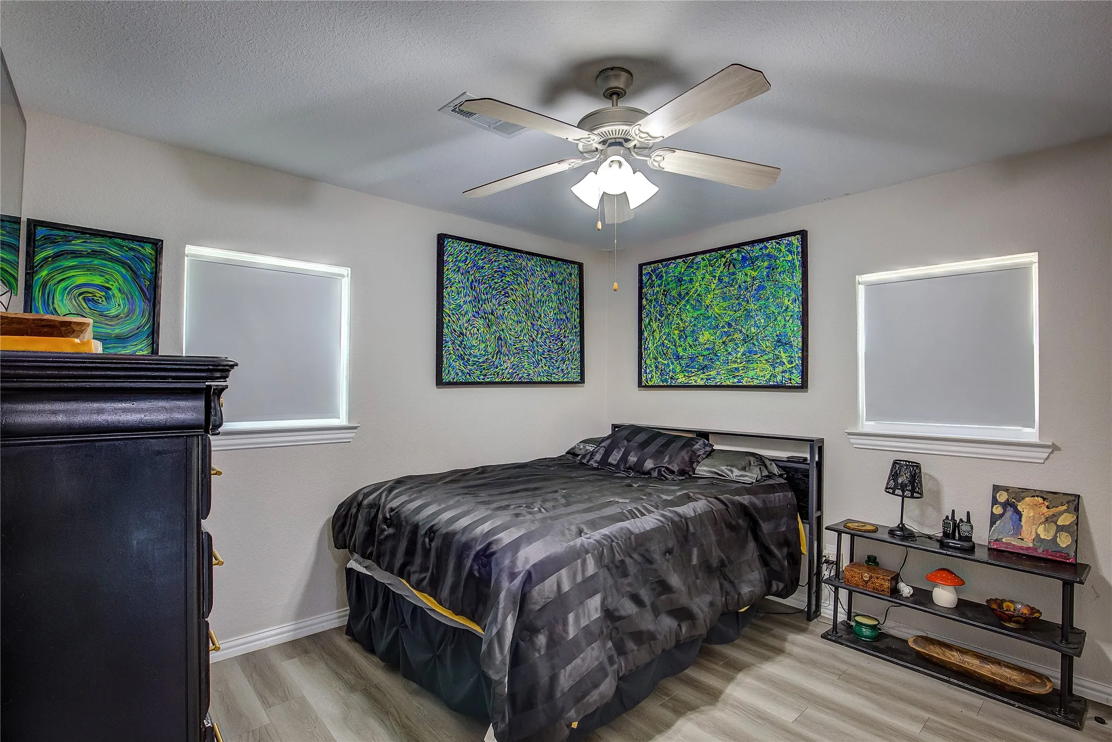 Bedroom featuring wood finished floors and a ceiling fan