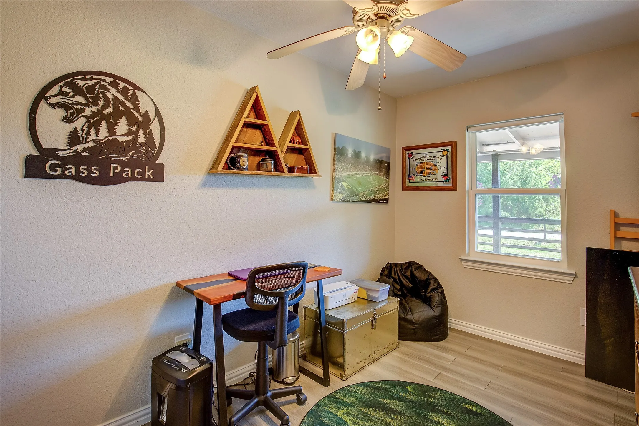 Office featuring wood finished floors, ceiling fan, and a textured wall