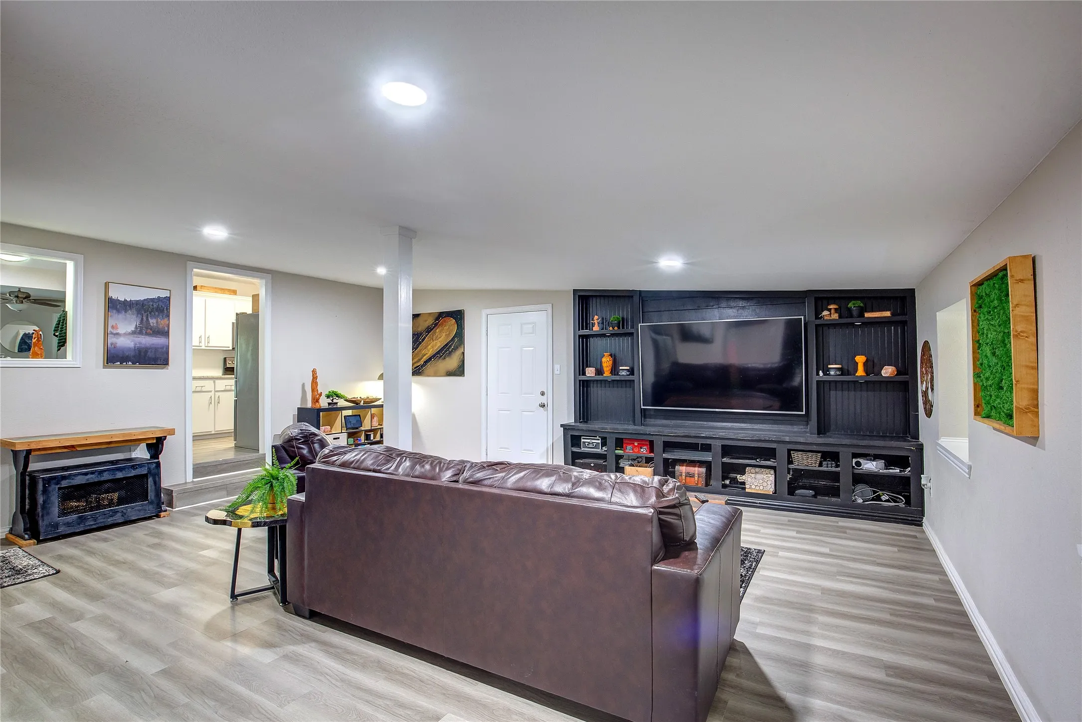 Living area featuring light wood-style flooring and recessed lighting