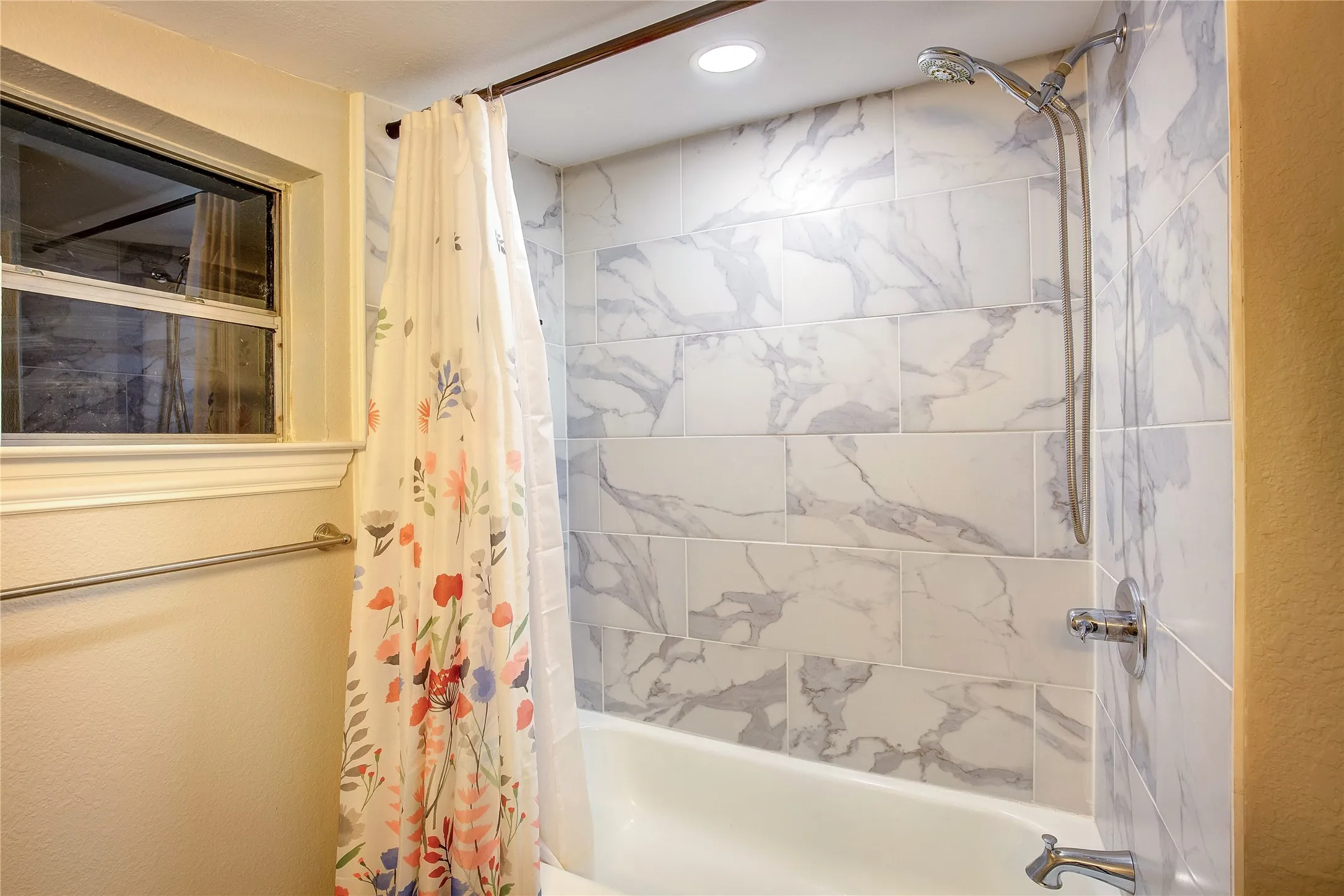 Bathroom featuring shower / bath combo with shower curtain
