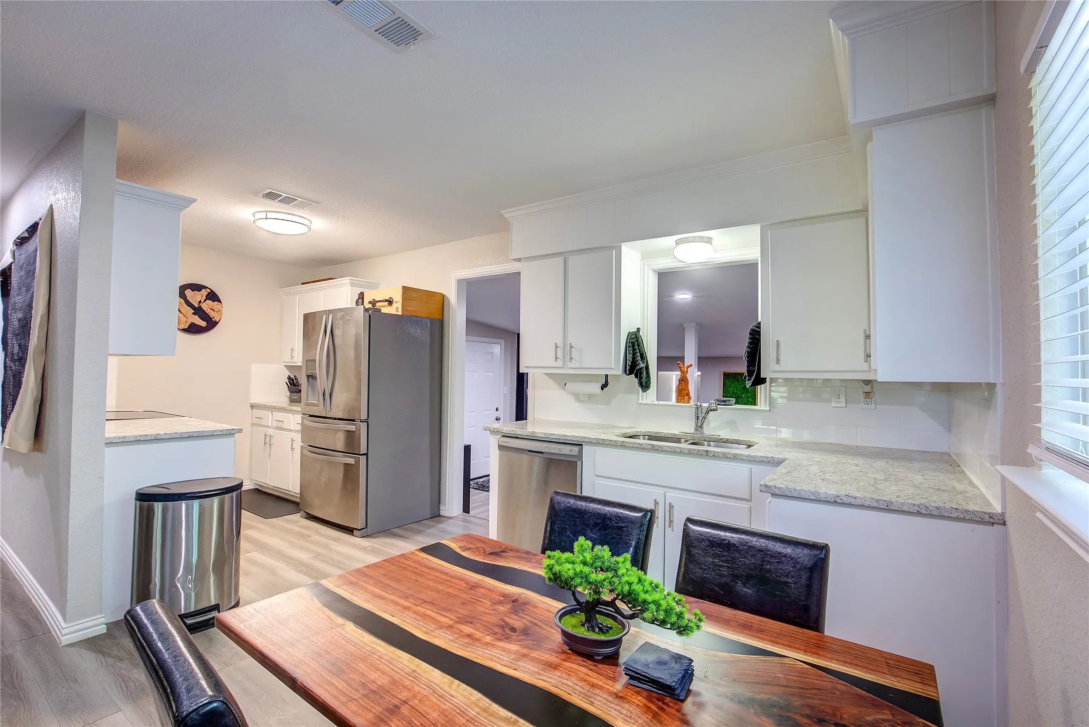 Dining space with light wood-type flooring and baseboards