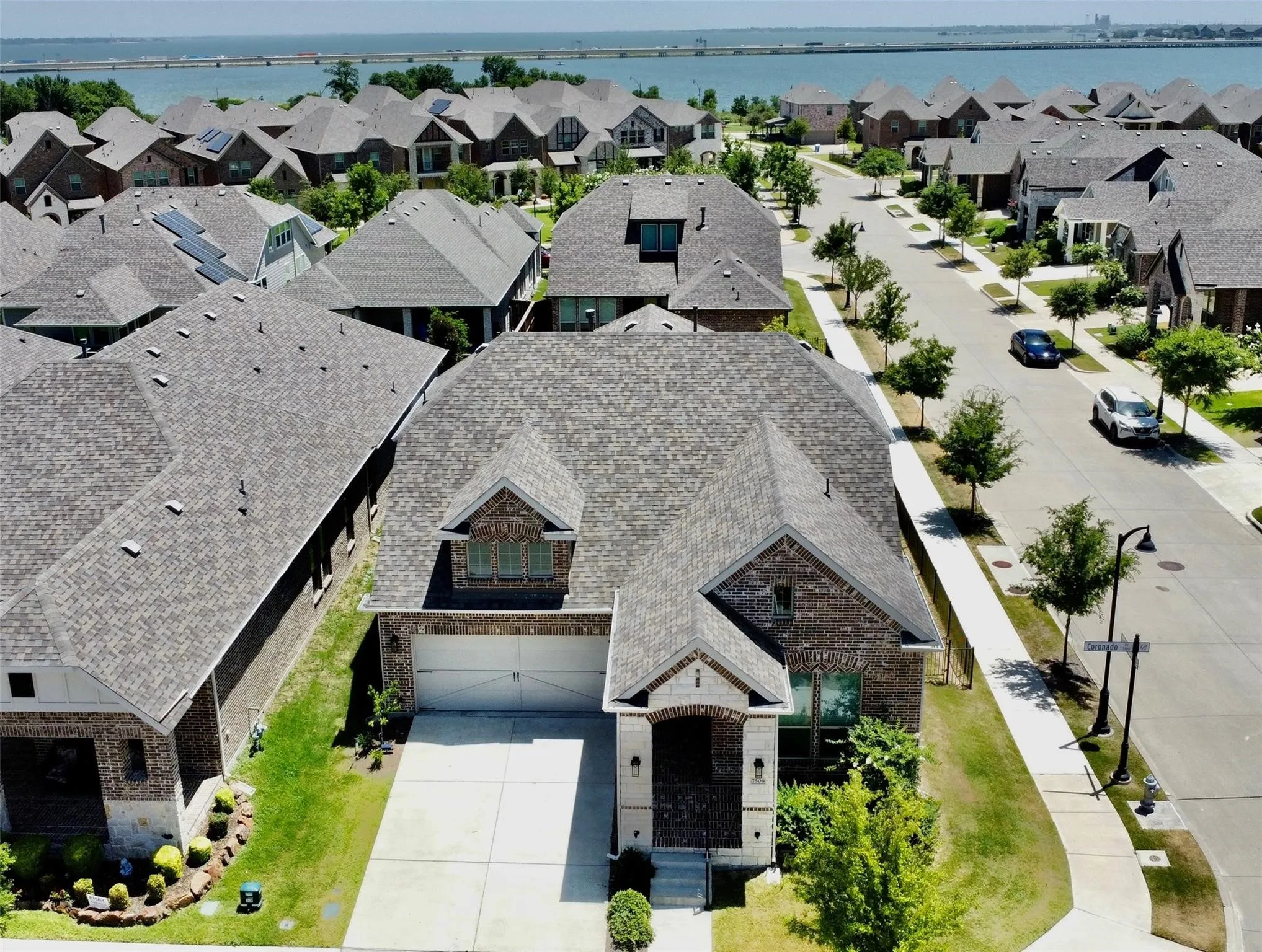 Brick and stone facade residence featuring an attached two-car garage