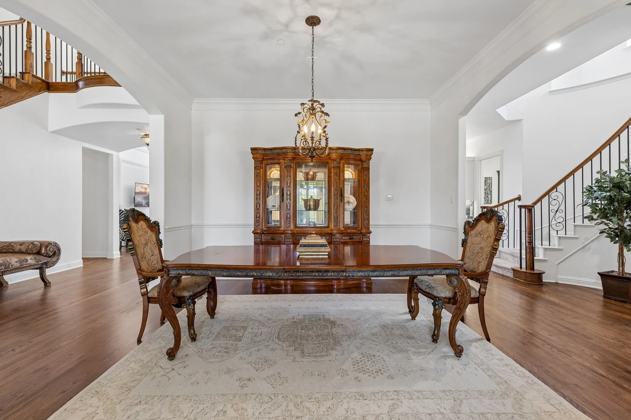 Formal dining area can comfortably fit a large table seating 10-12 with views of the beautiful wine cellar which is not pictured here. Staircase #2 is off the kitchen and next to the garage entrance.