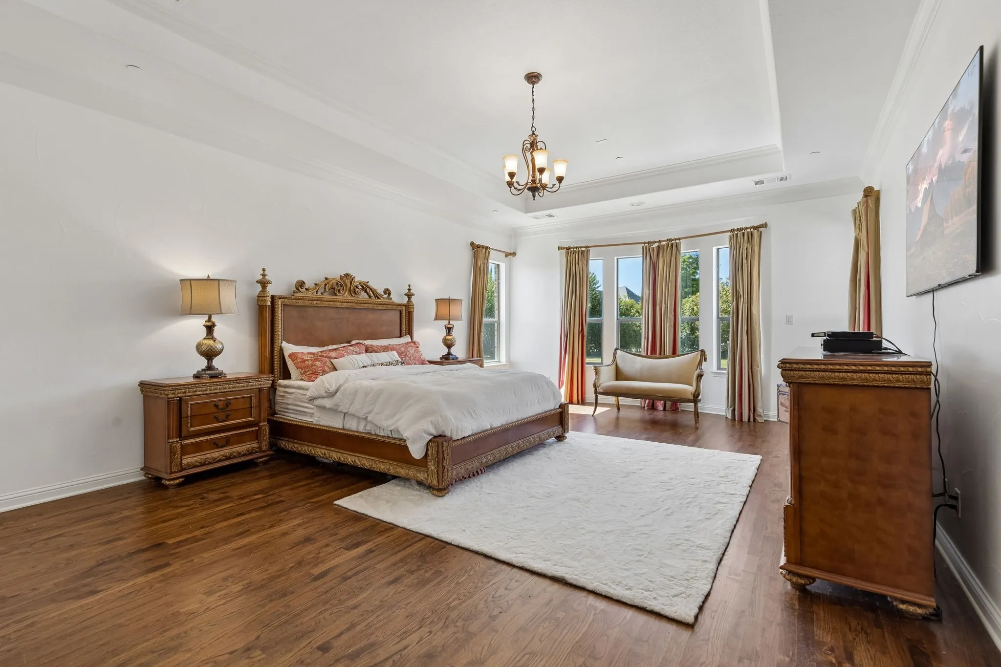 The primary bedroom is separated from the rest of the home and has a large seating area with nature view of the backyard through every window.
