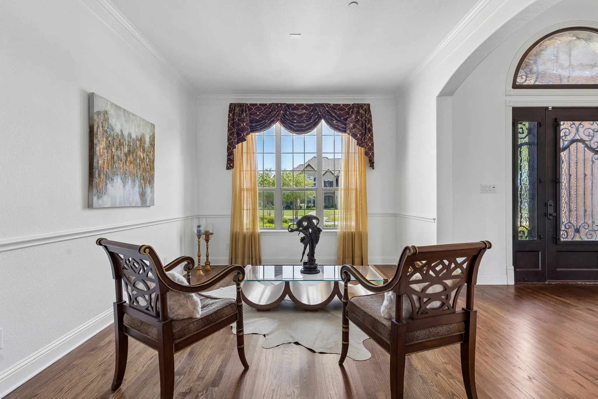 This formal living room at the home's entry beautifully flows into the dining area making it the perfect for entertaining.