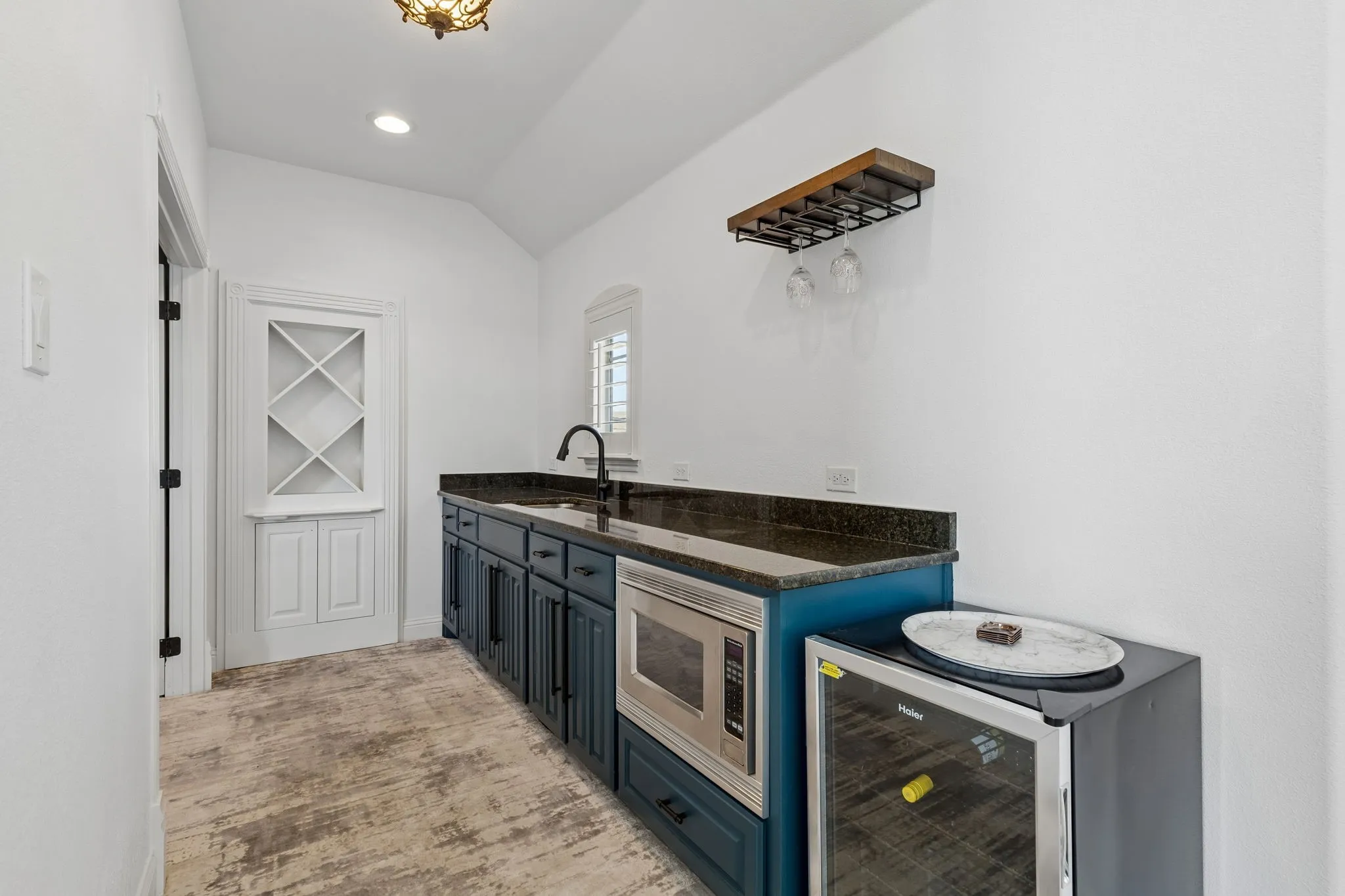 Ready for movie night? This wet bar featuring a sink and microwave make entertaining upstairs so easy.