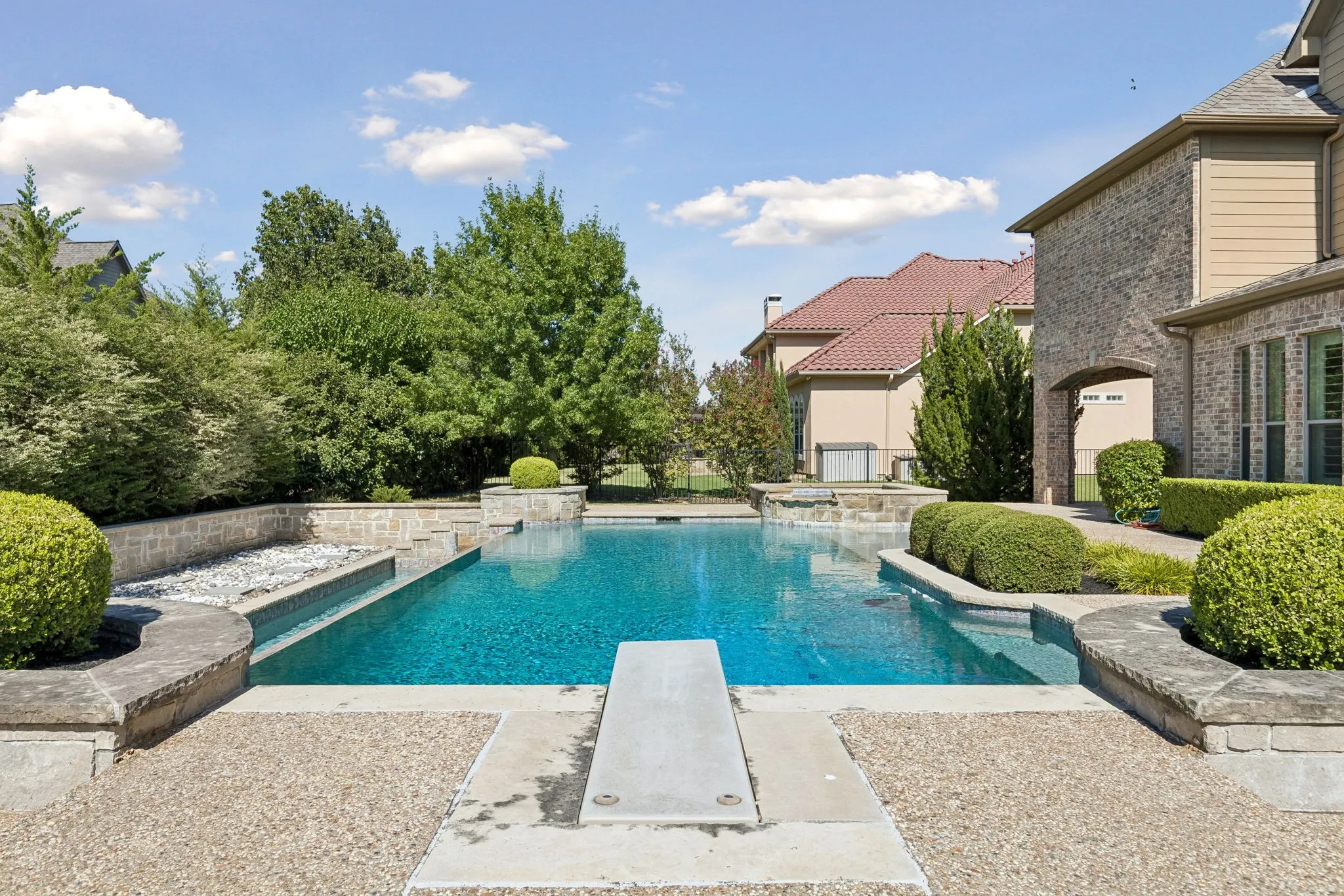 Infinity Edge swimming pool with spa. Ask agent for virtual design options around the current rock garden.
