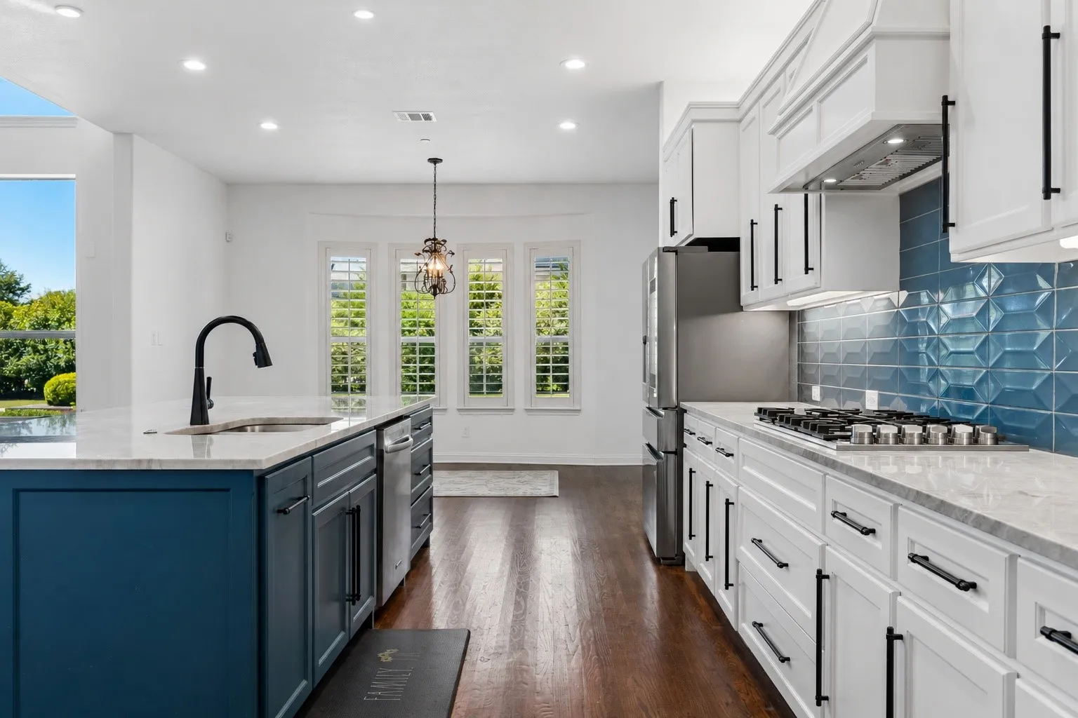Kitchen featuring a central island with storage and offers a 6 burner gas-top range.