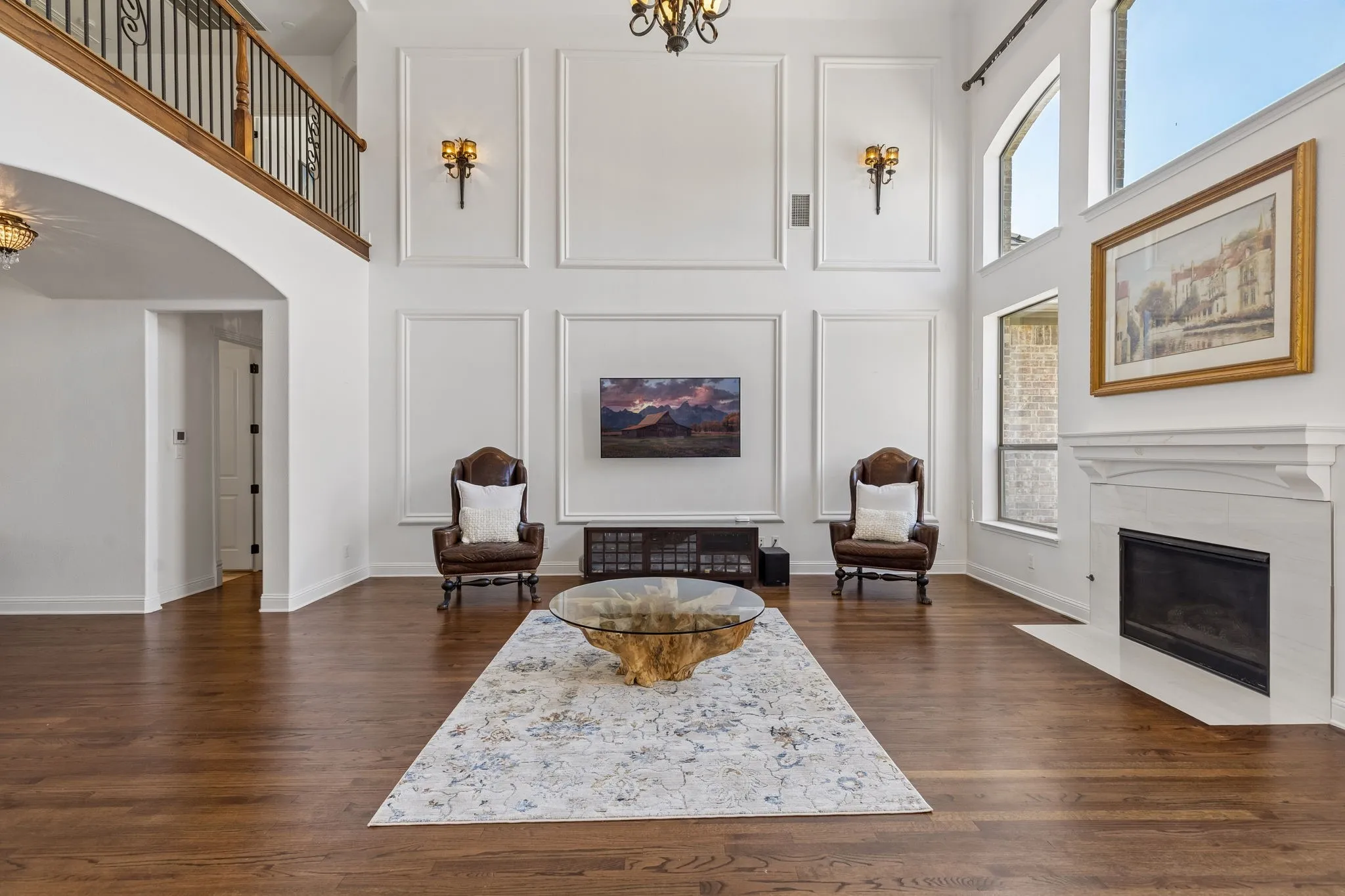 This beautiful fireplace is perfectly positioned by oversized windows making quite the statement.