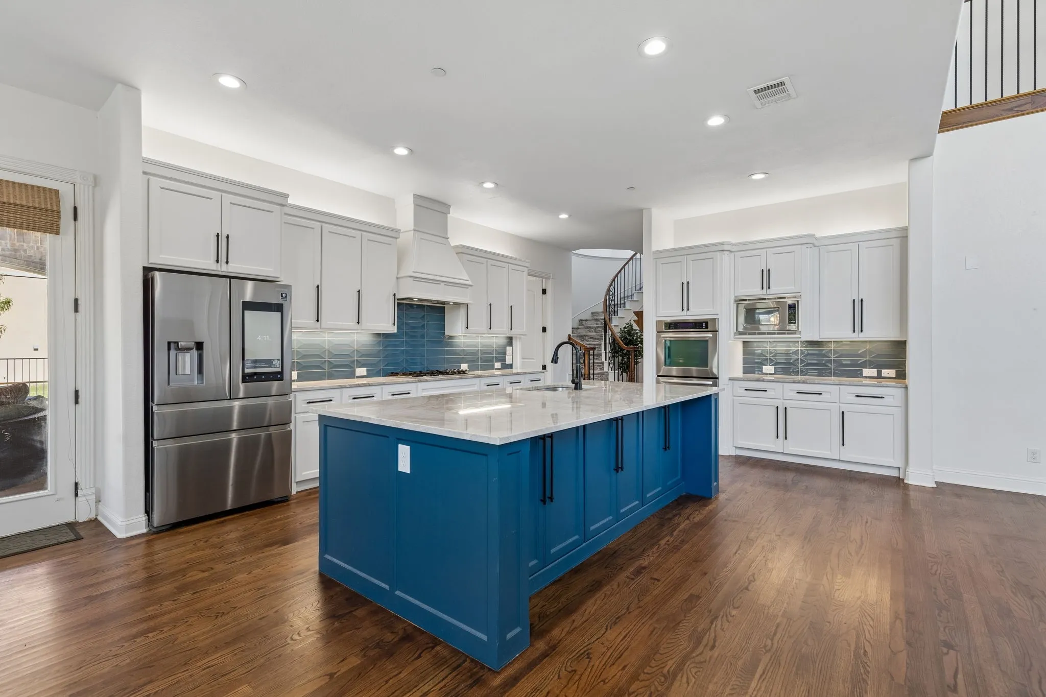 Modernized and updated gourmet kitchen featuring  double ovens and top of the line GE appliances.