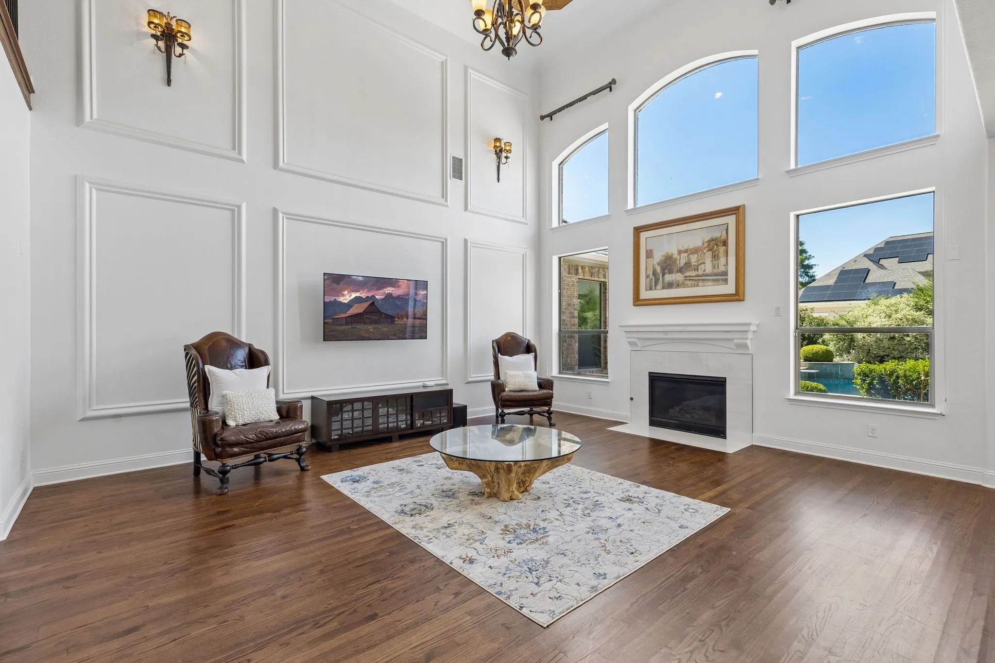 The main living room features a stunning view of the pool and backyard with loads of cascading light!