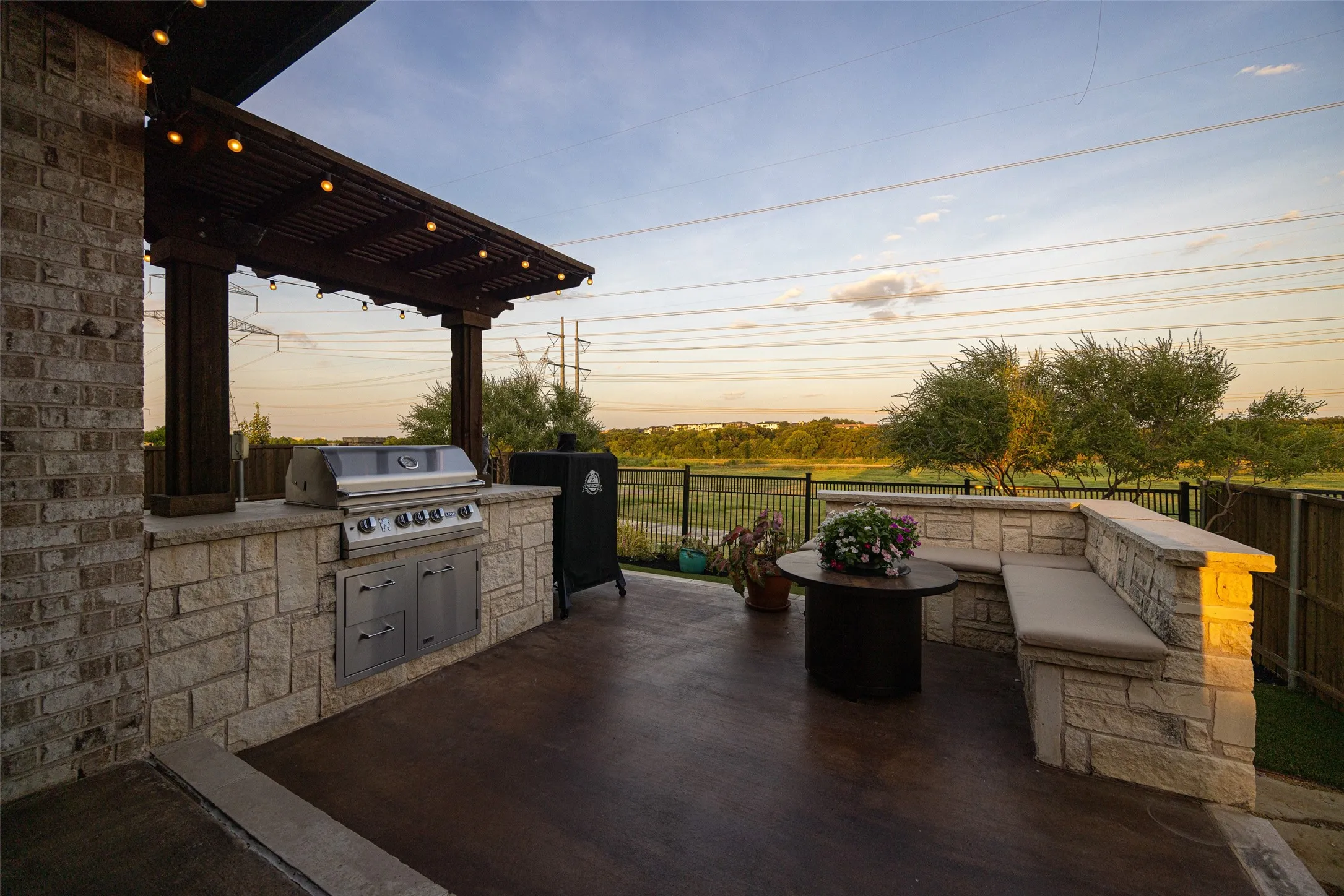 Outdoor kitchen featuring a built-in grill and integrated cabinetry