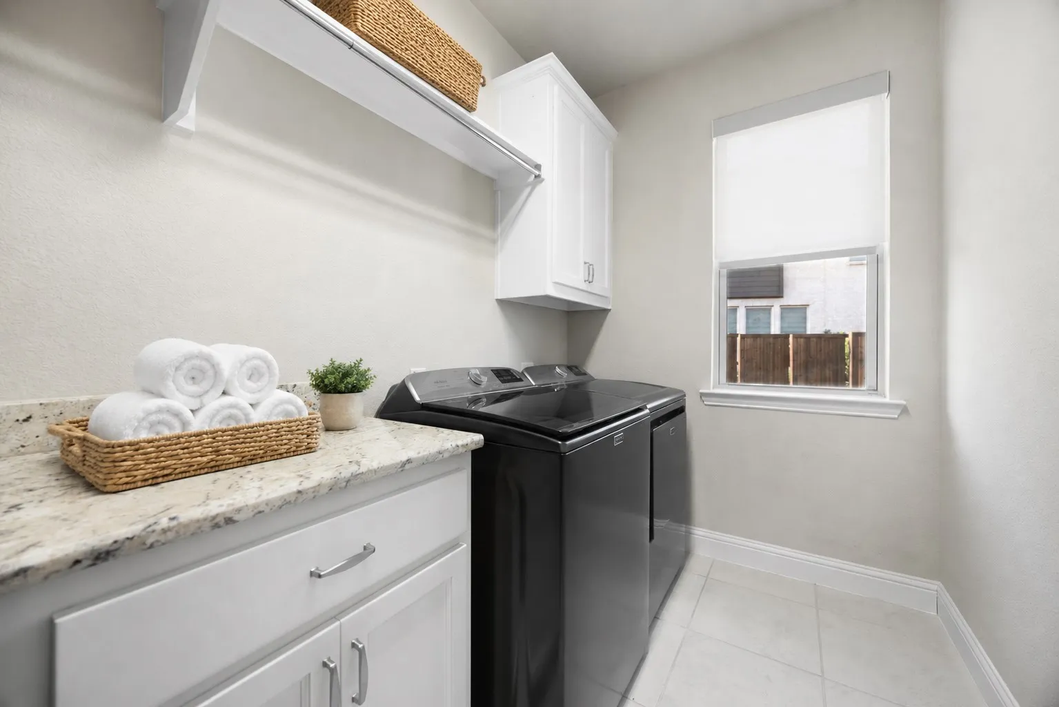 Laundry room lots of light and built-in cabinets and shelves!