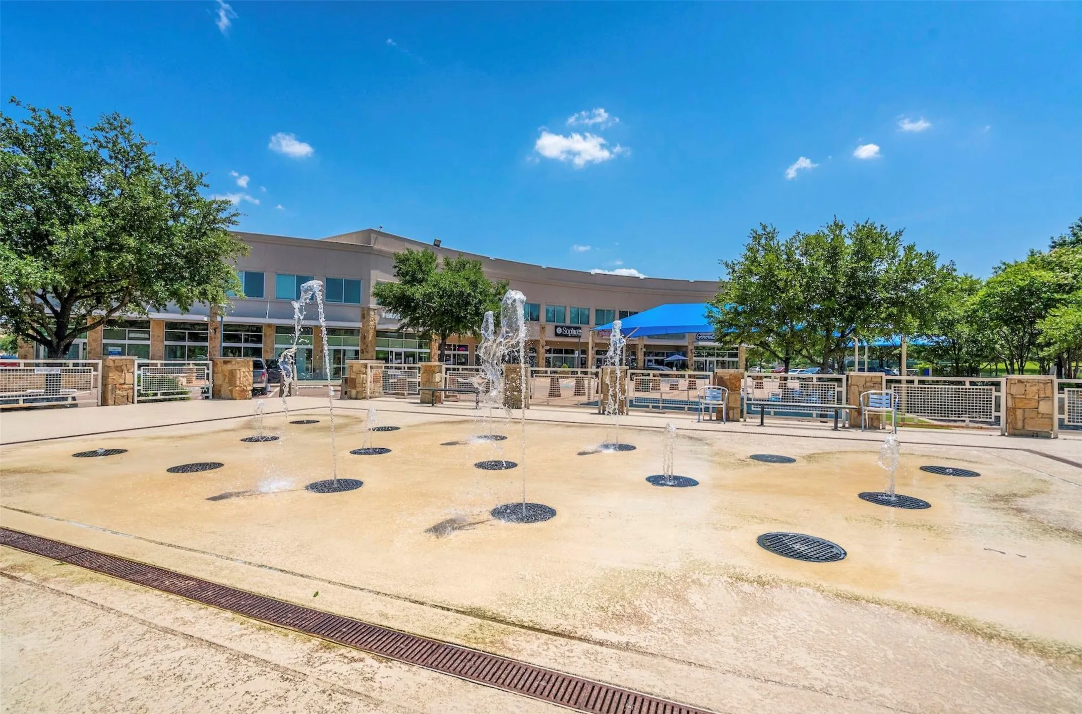 Outdoor splash pad featuring multiple water jets set within a paved surface