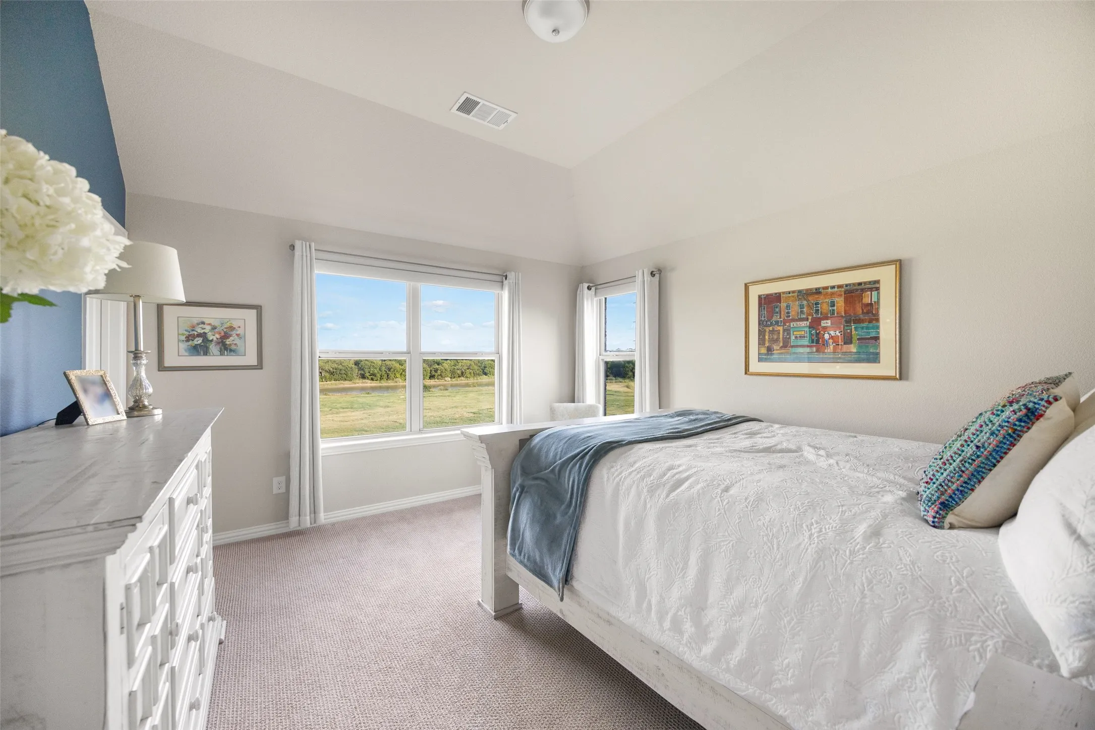 Room featuring a vaulted ceiling and dual pane windows