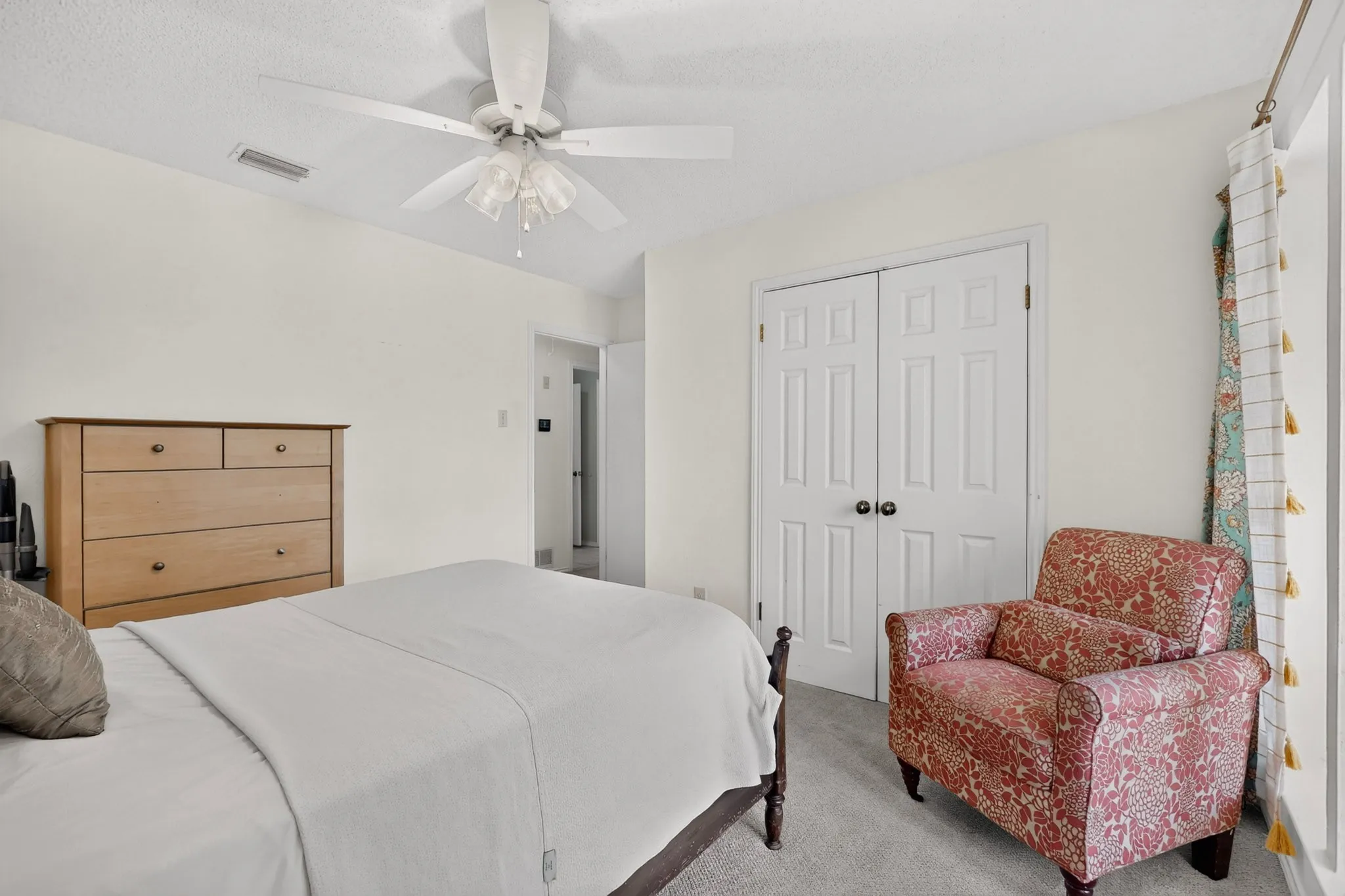 Interior room featuring light-colored walls and grey carpet flooring
