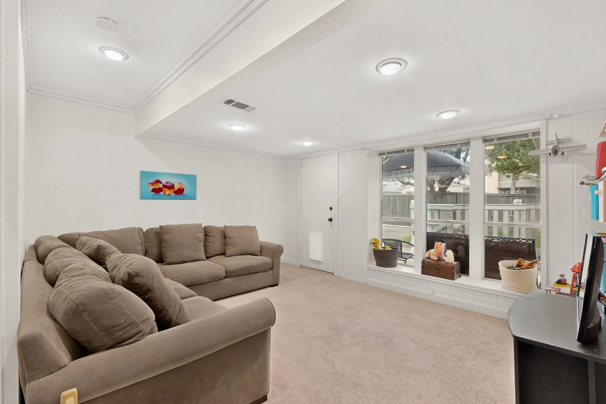 Carpeted interior space featuring recessed lighting and crown molding