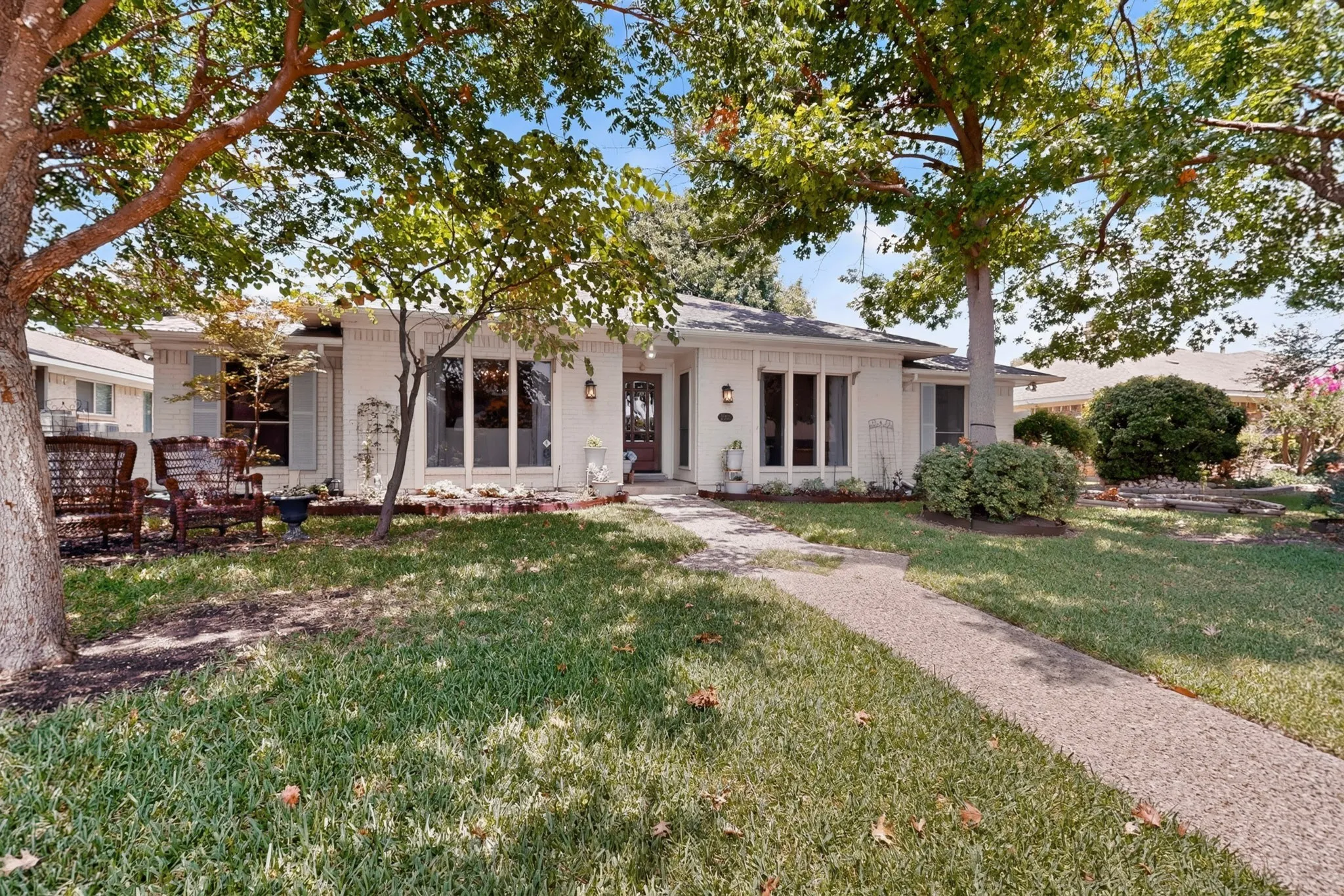 White brick exterior featuring large bay windows