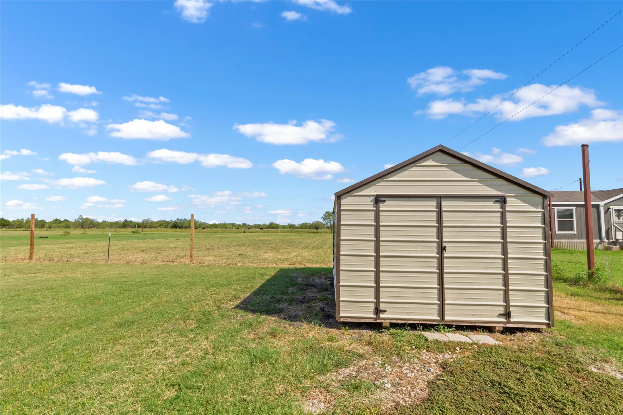 Metal storage shed with double doors and a gable roof