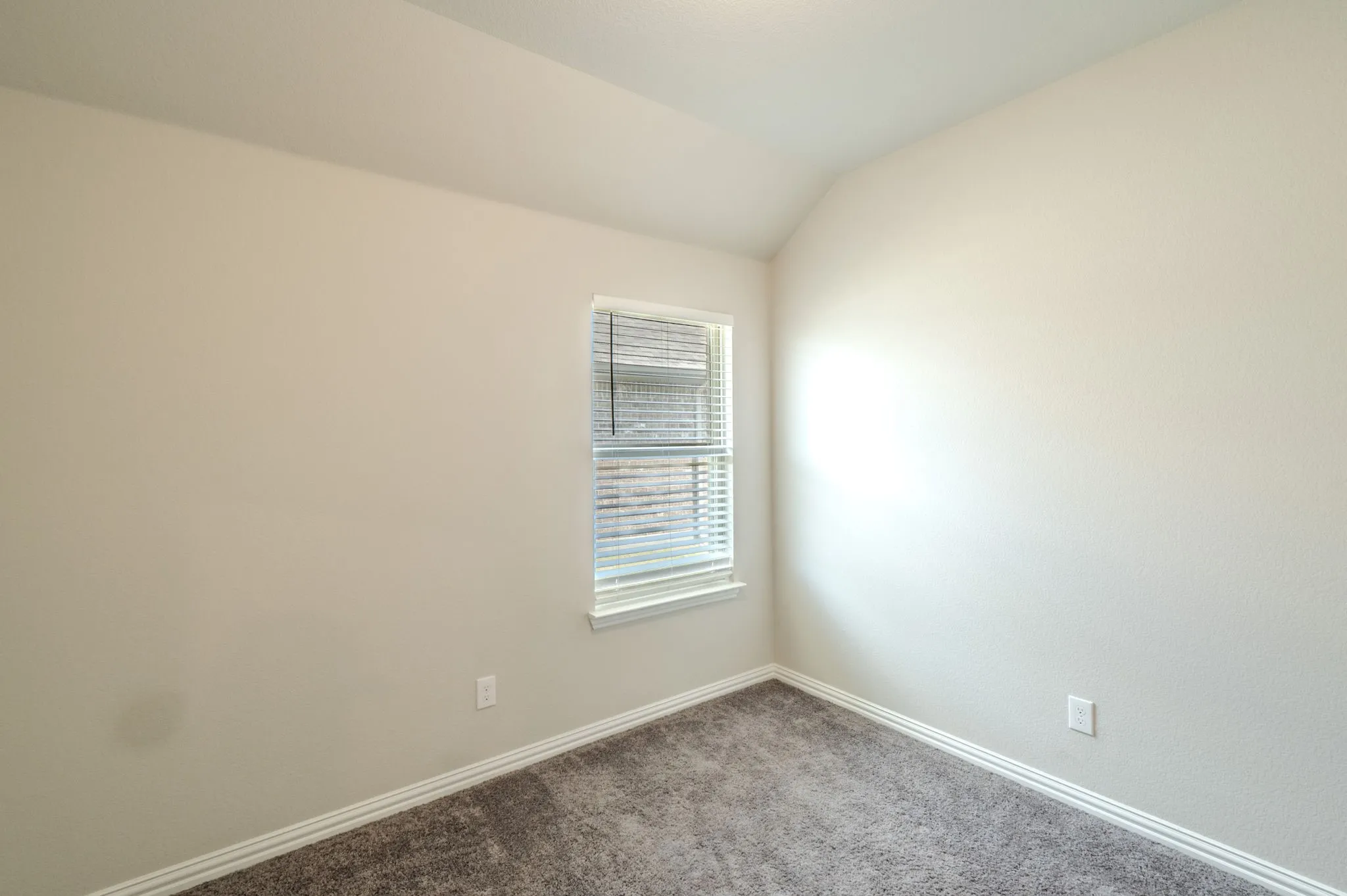 Secondary Bedroom with carpet and nuetral paint.