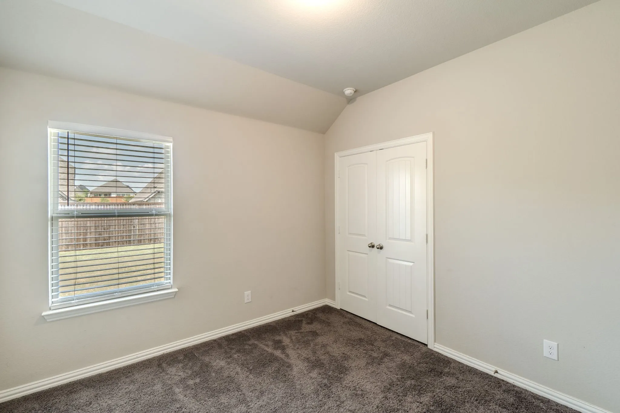Secondary bedroom with carpet and closet.
