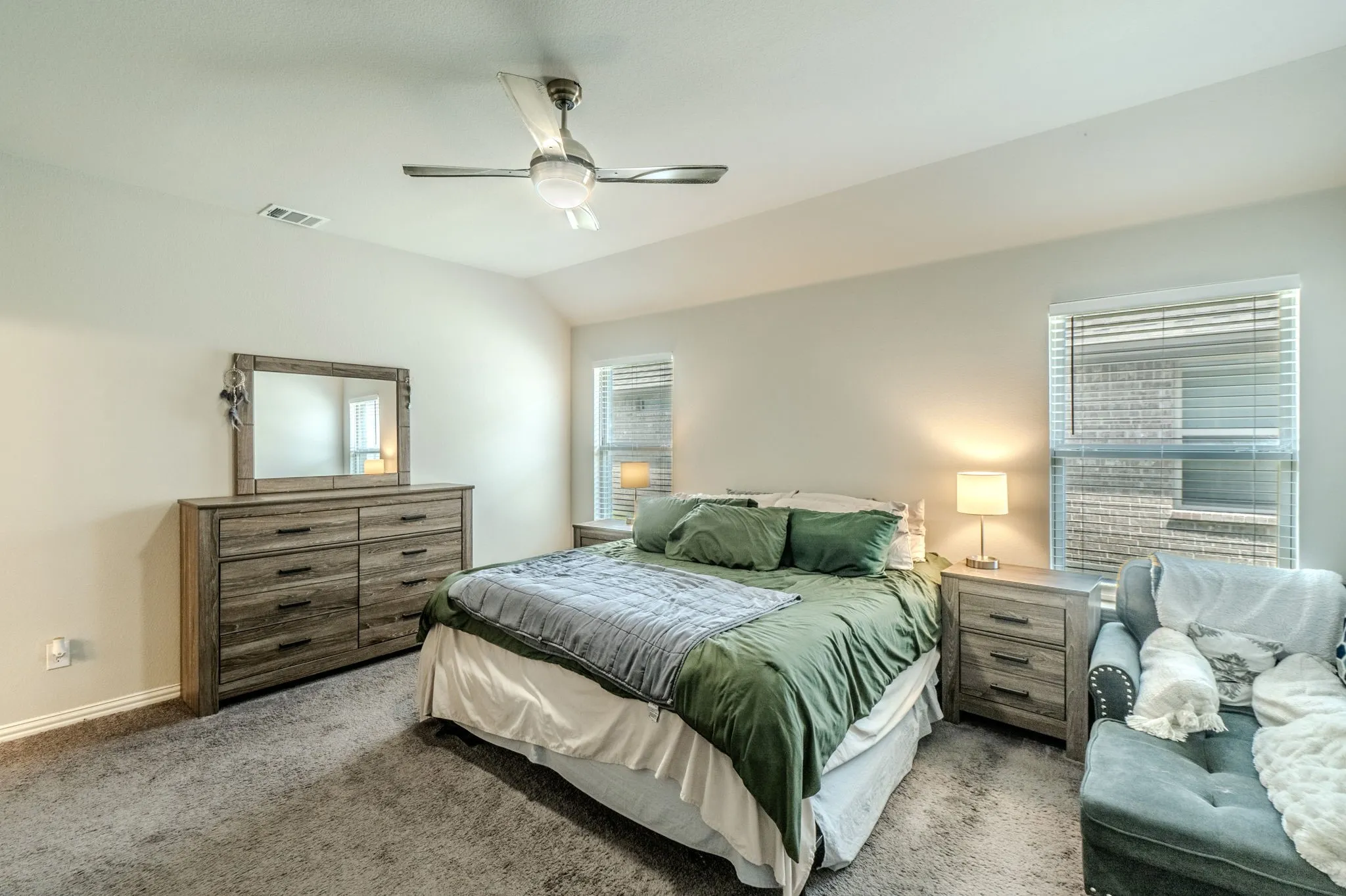 Primary Bedroom with lots of light and space. Carpeted floor and ceiling fan provides good comfort.