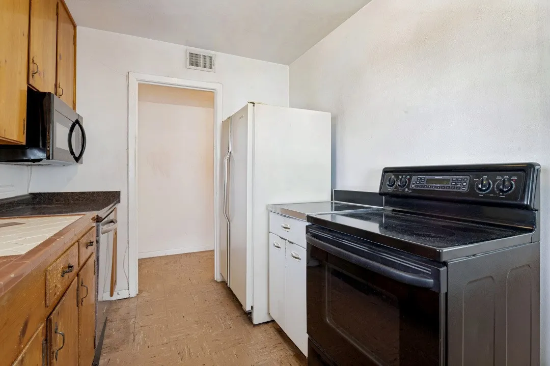 Black Oven Range with Utiilty Storage cabinet and Refrigerator