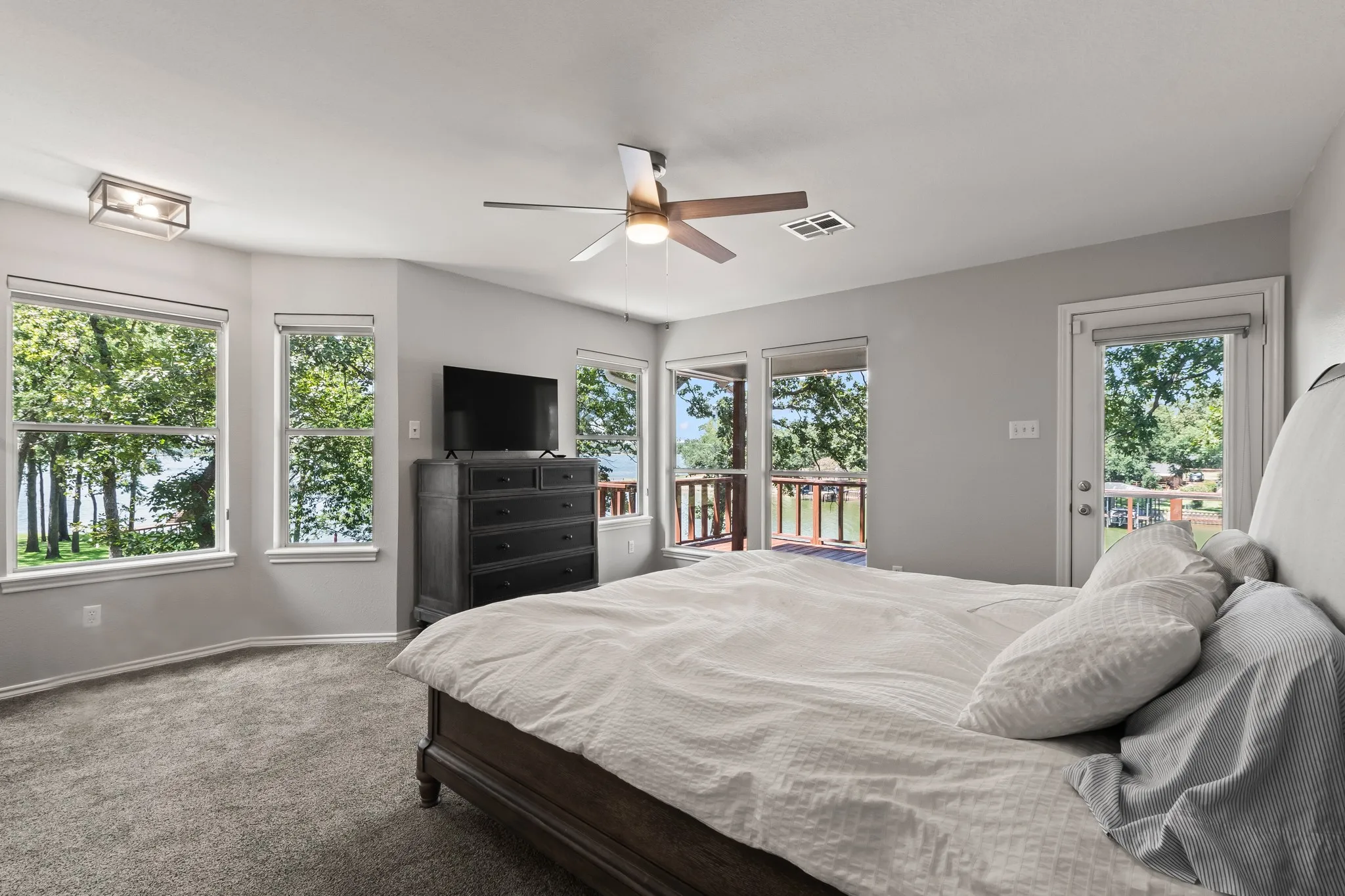 Upstairs Primary Suite with elevated views of open water and access to a balcony.