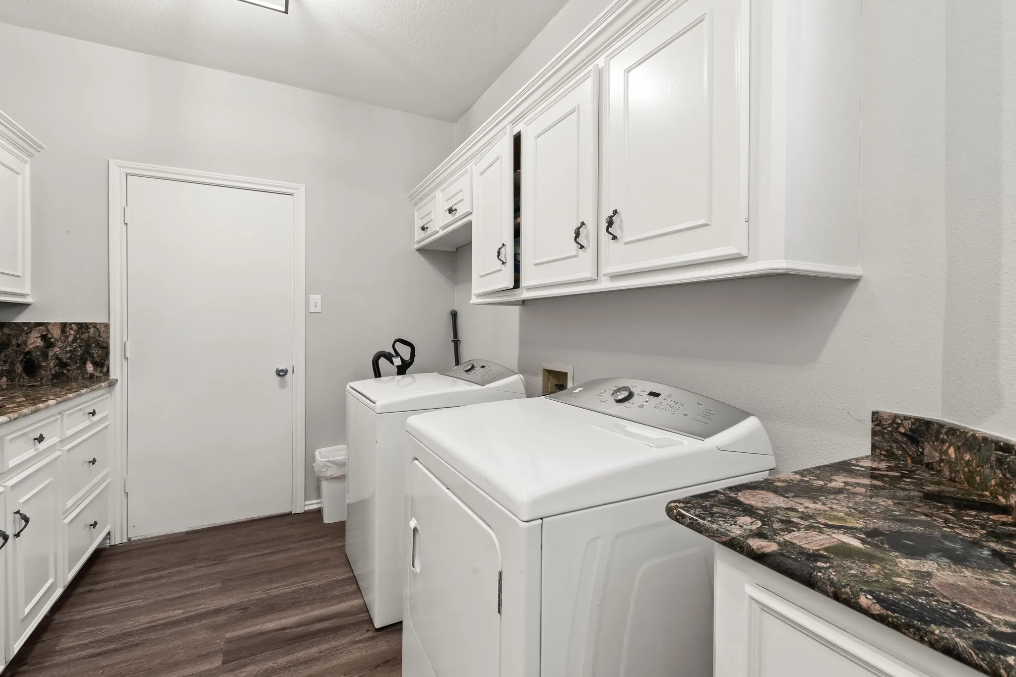 Utility room with sink and folding space.