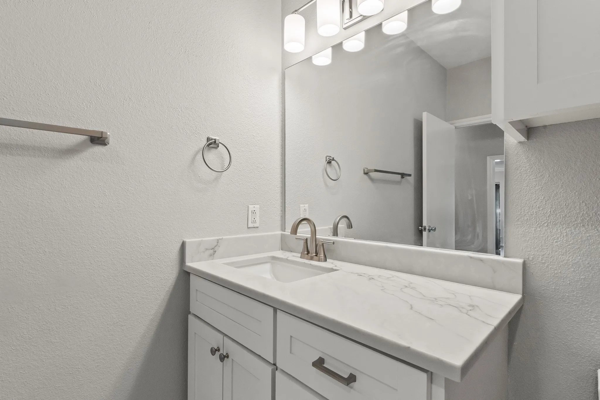 All bathrooms in the home feature beautiful updates like modern fixtures and quartz countertops.