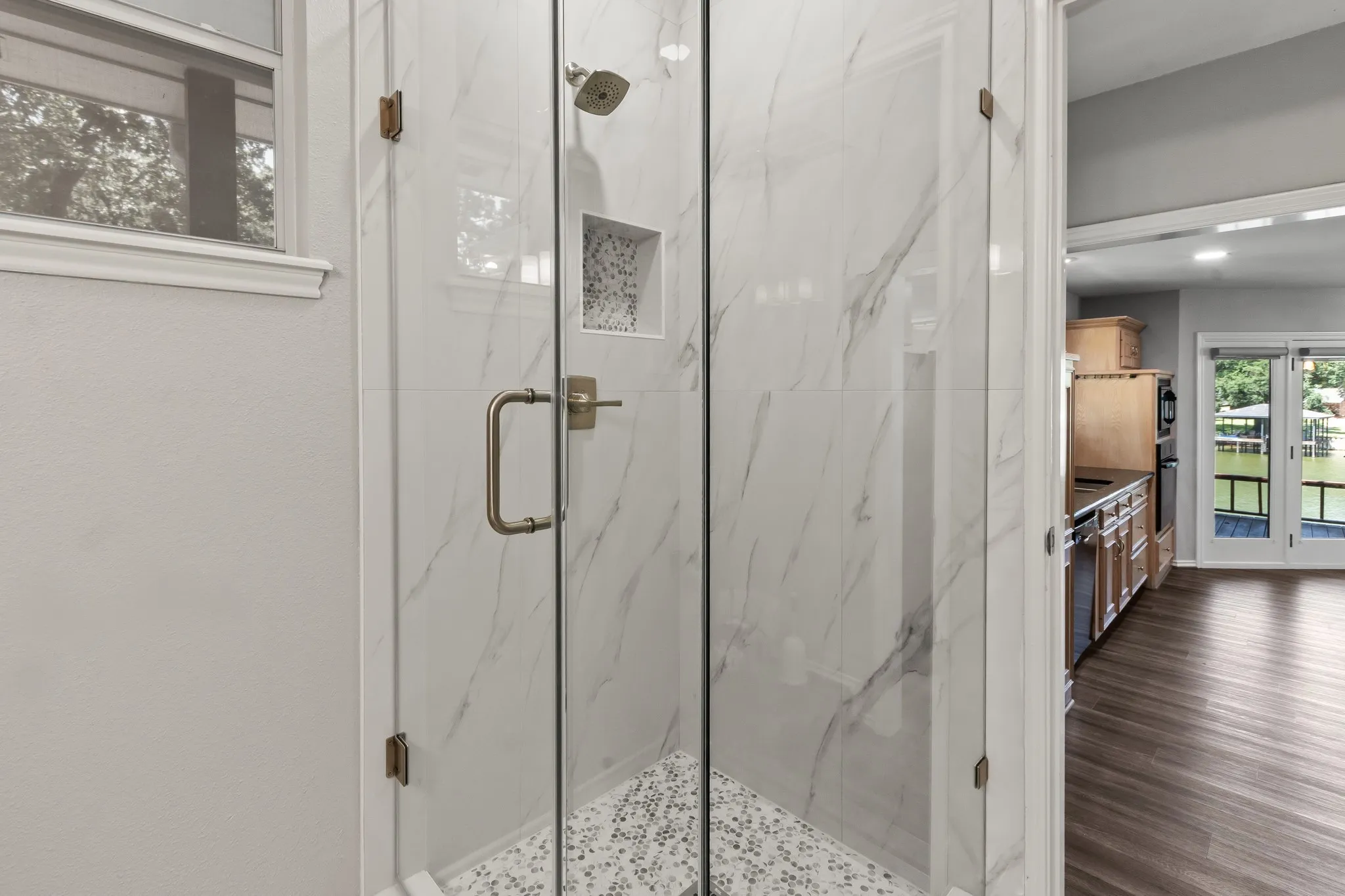 Full bath with walk in tile shower located on the main floor just off side door to deck.