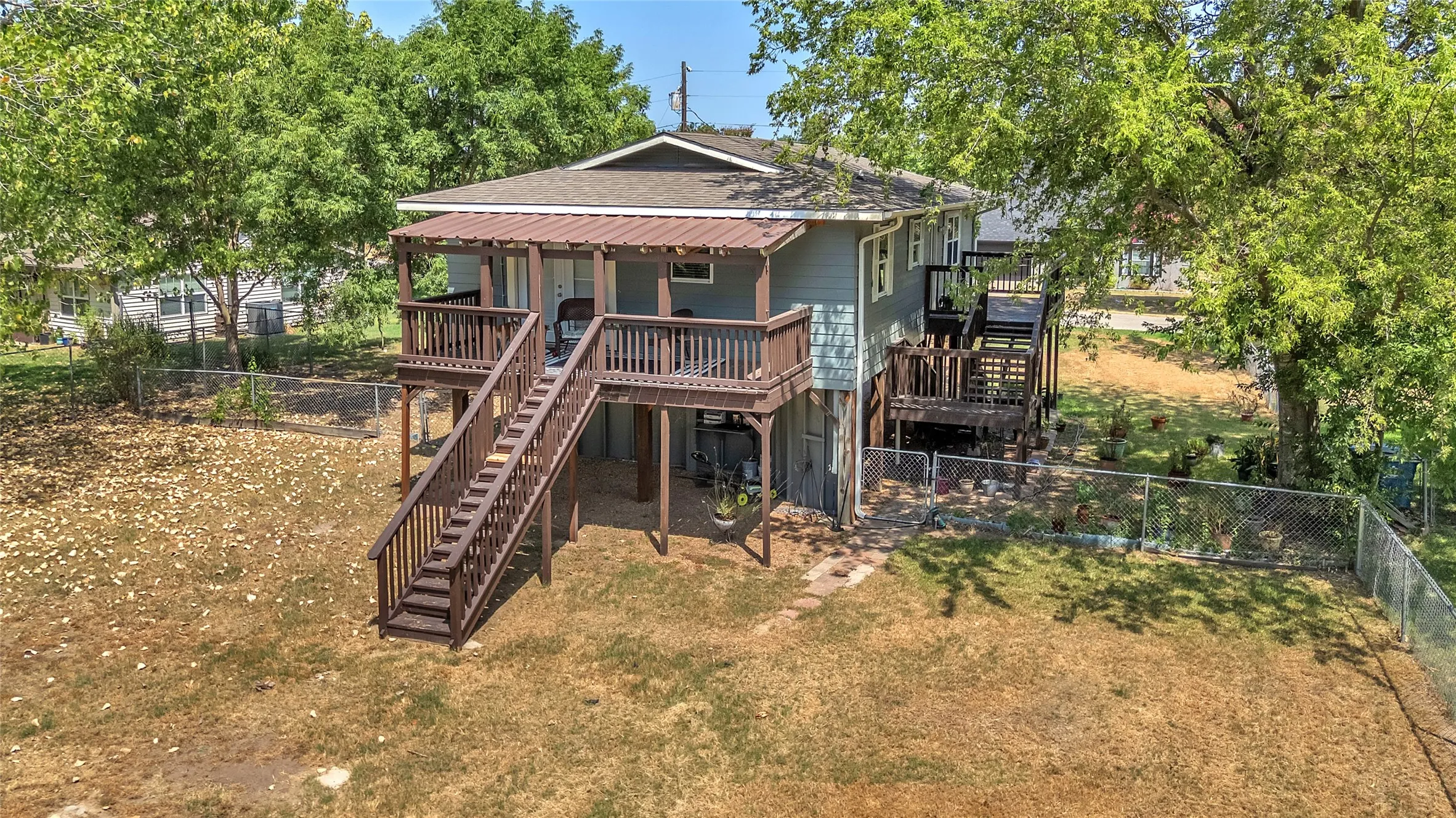 Decks on side and back for enjoying nature and large fenced yard.