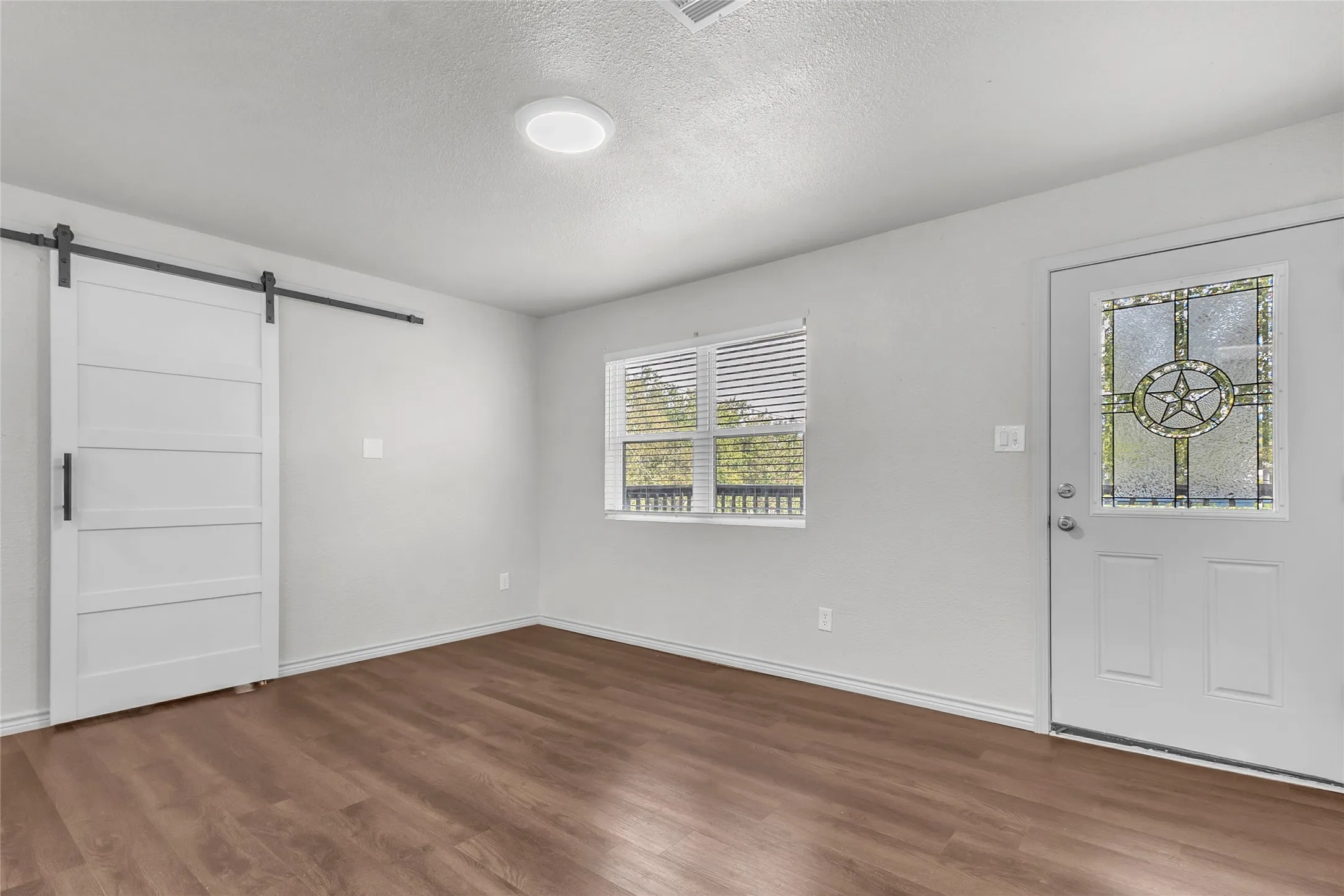 Open Plan with front door entering living area. Barn door to 3rd bedroom or office