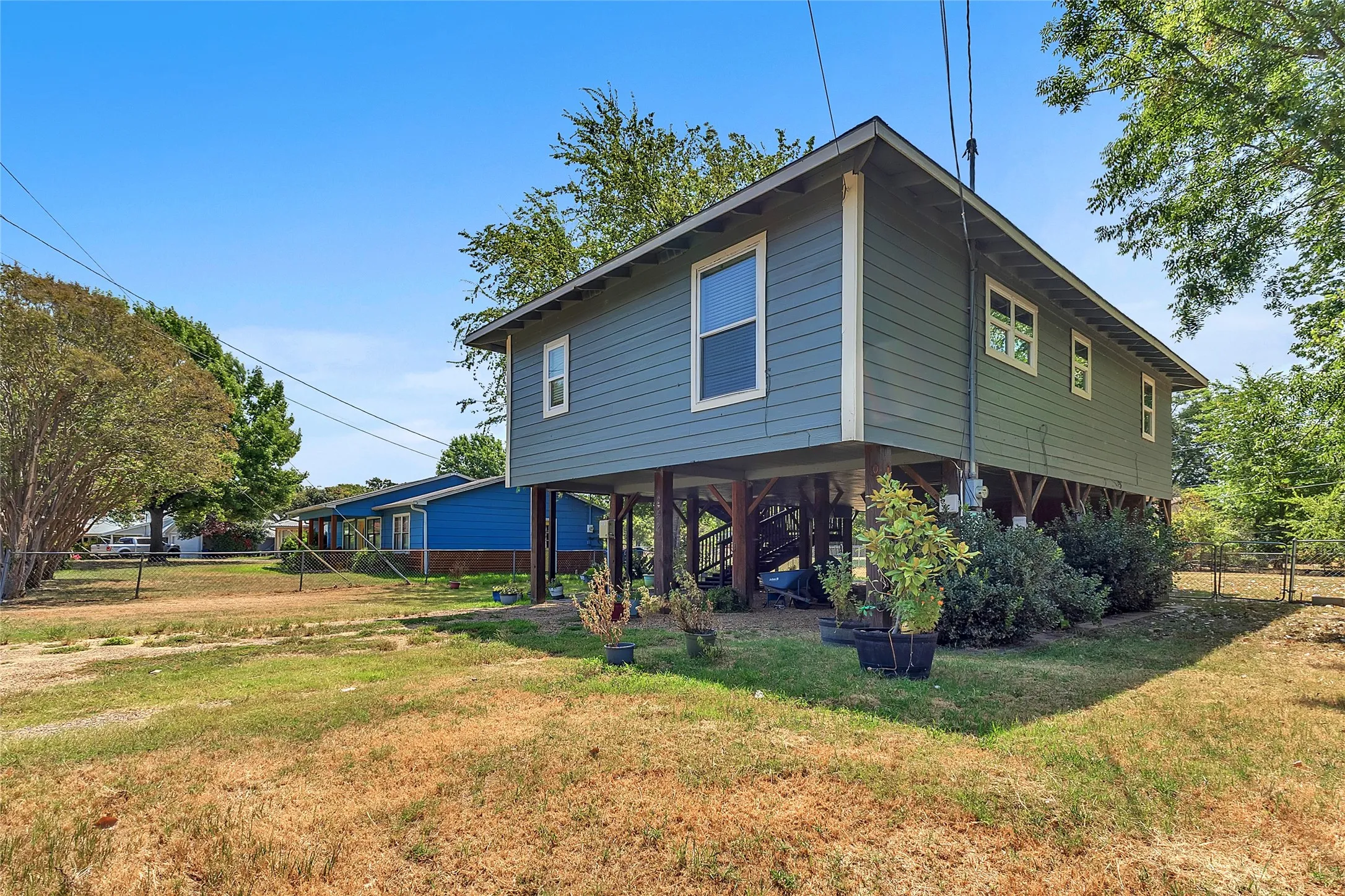 Front and side of home. Carport with pea gravel drive