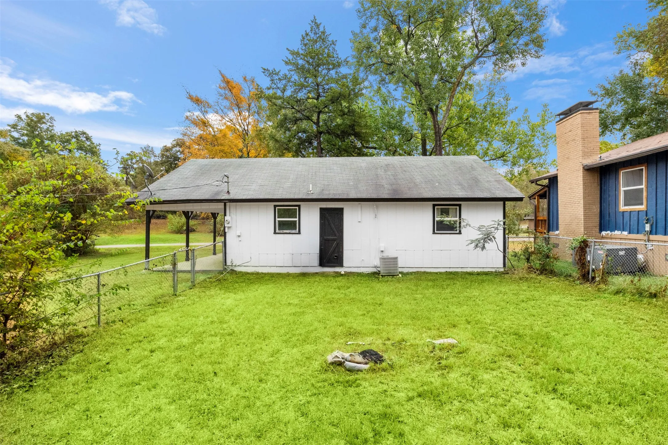 Rear exterior with white siding and black trim details