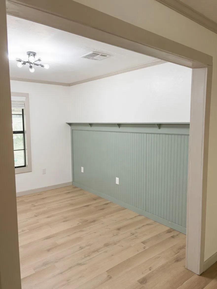 Entryway opening into  dining room featuring wood-finish flooring, and natural light & green beadboard accent wall with a built-in shelf, and a modern ceiling light fixture
