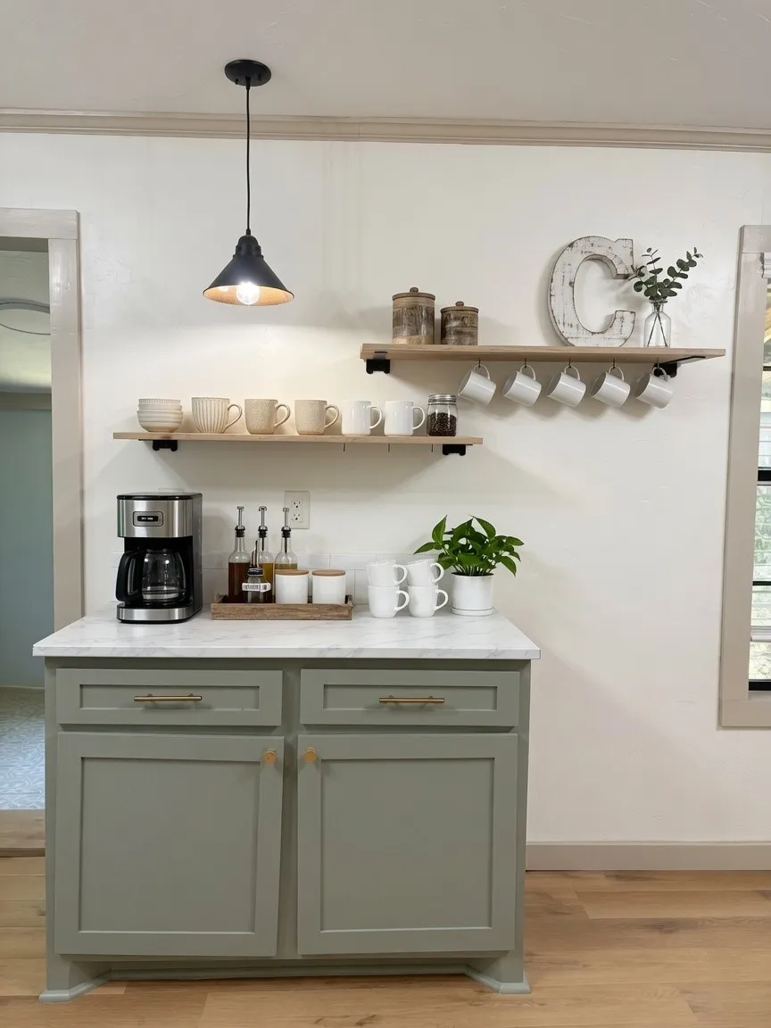 Custom cabinetry with a light gray finish, brass hardware, and a light-toned countertop
